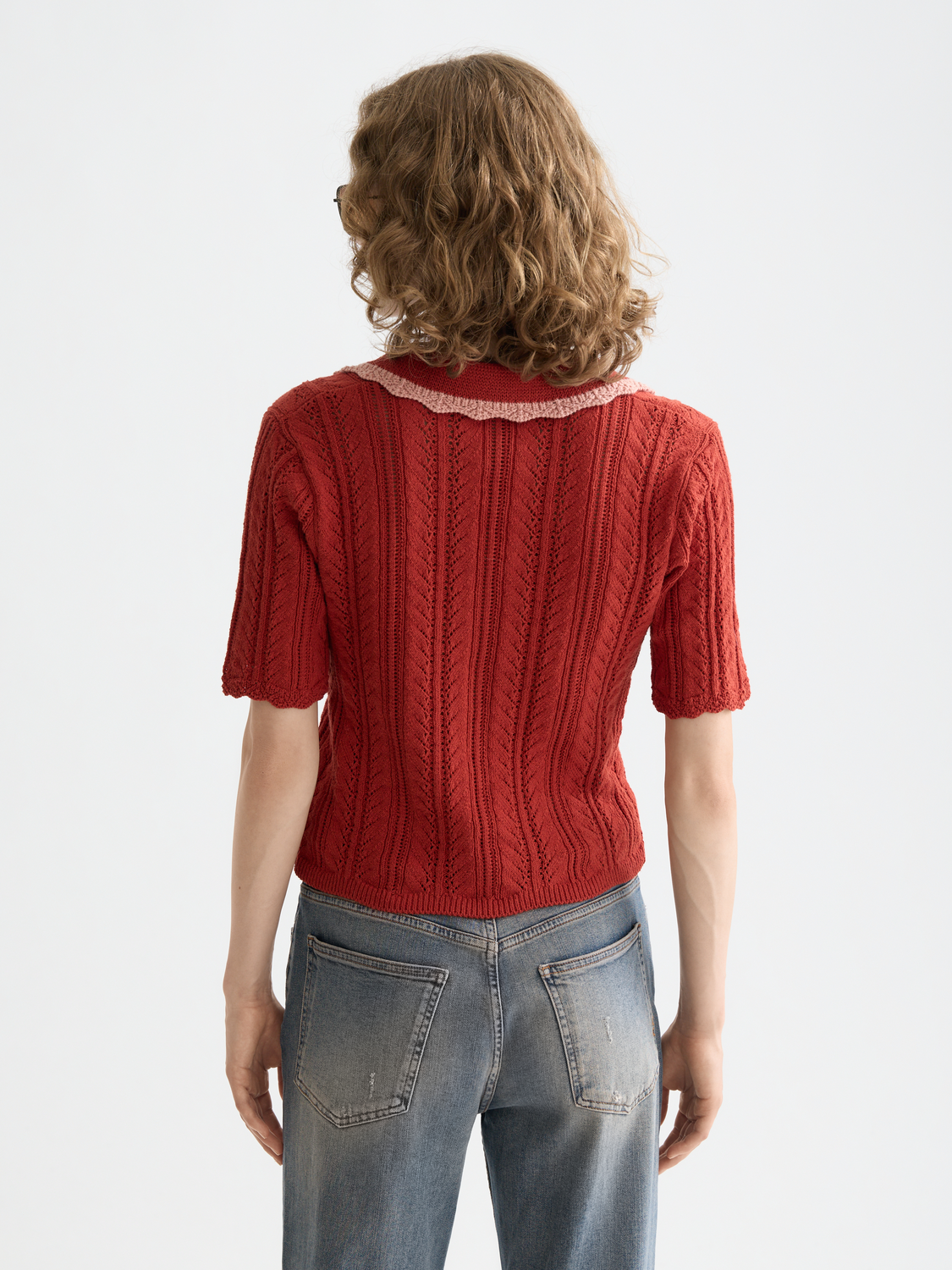 Black Pointelle collared polo knitwear by Scotch & Soda, featuring a textured pattern and classic polo design.