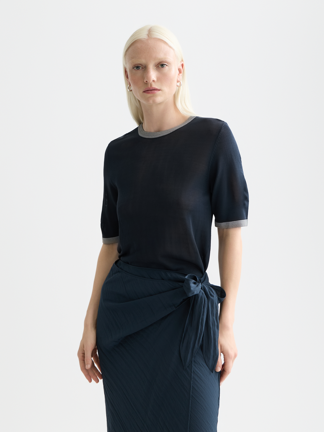 Short-sleeved knit pullover by Scotch & Soda, featuring a classic crew neck and textured knit pattern in neutral tones.
