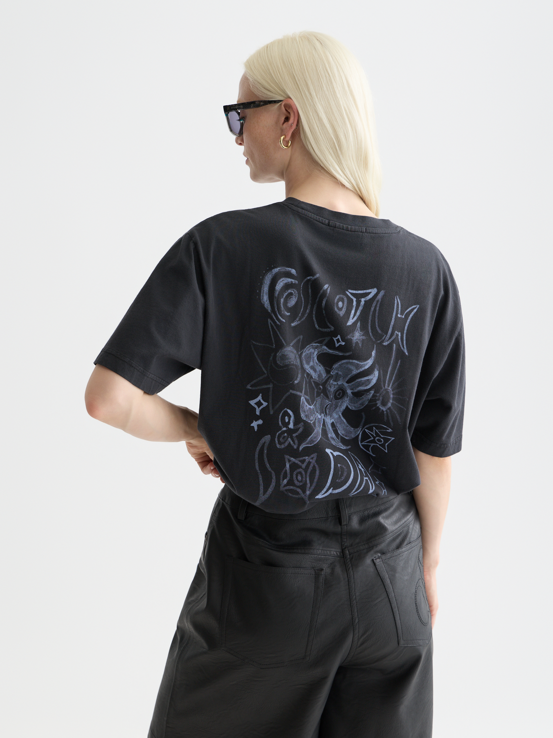 Scotch & Soda short-sleeve artwork t-shirt featuring a colorful graphic design on the back.