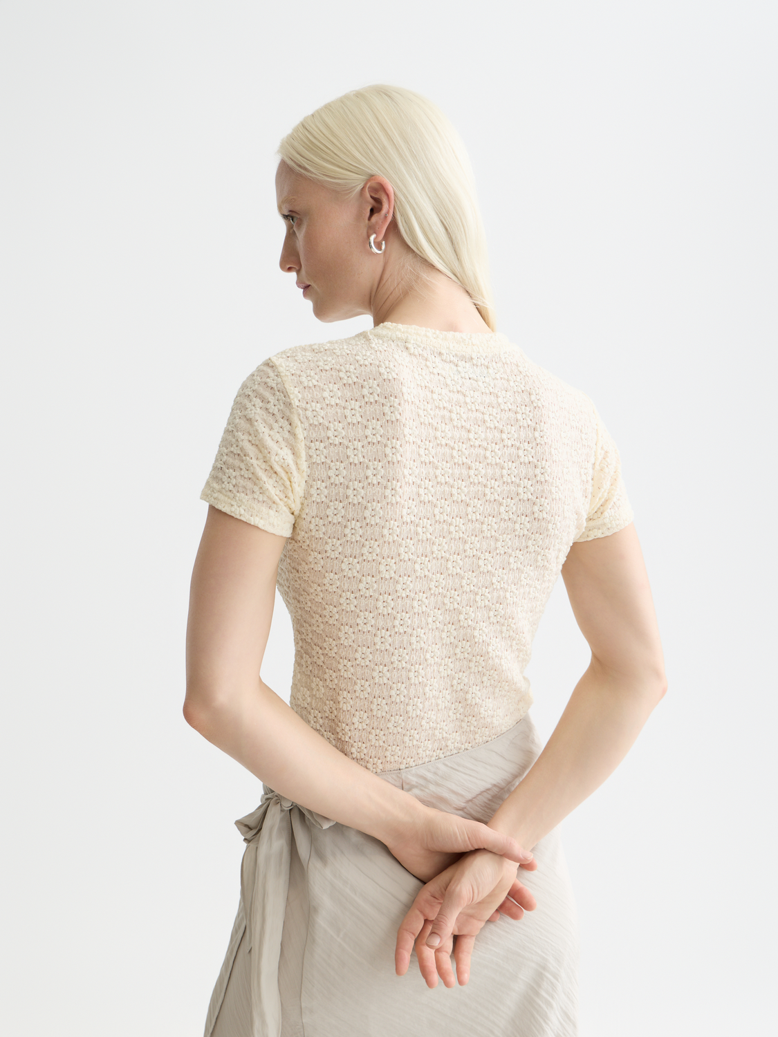 Light blue Scotch & Soda open-structure short-sleeve t-shirt with a relaxed fit, displayed from the back with a textured design.