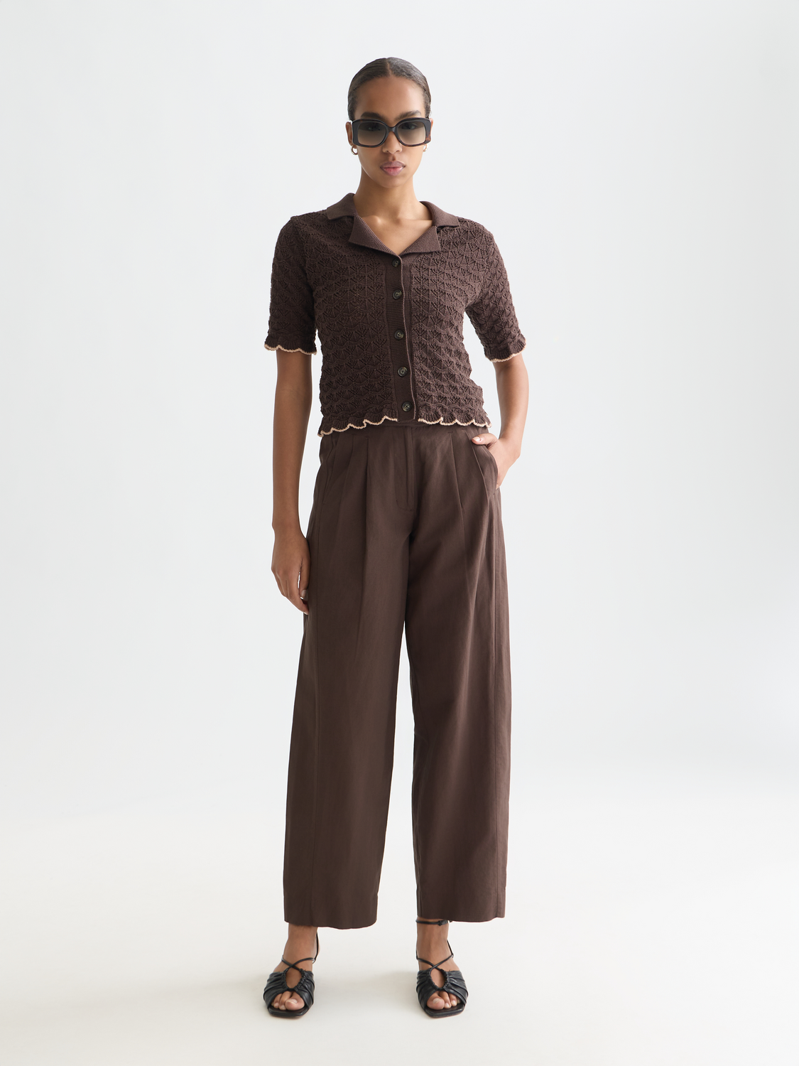 Pointelle short-sleeved cardigan from Scotch & Soda, lightweight knitwear with delicate openwork pattern, in soft neutral color.