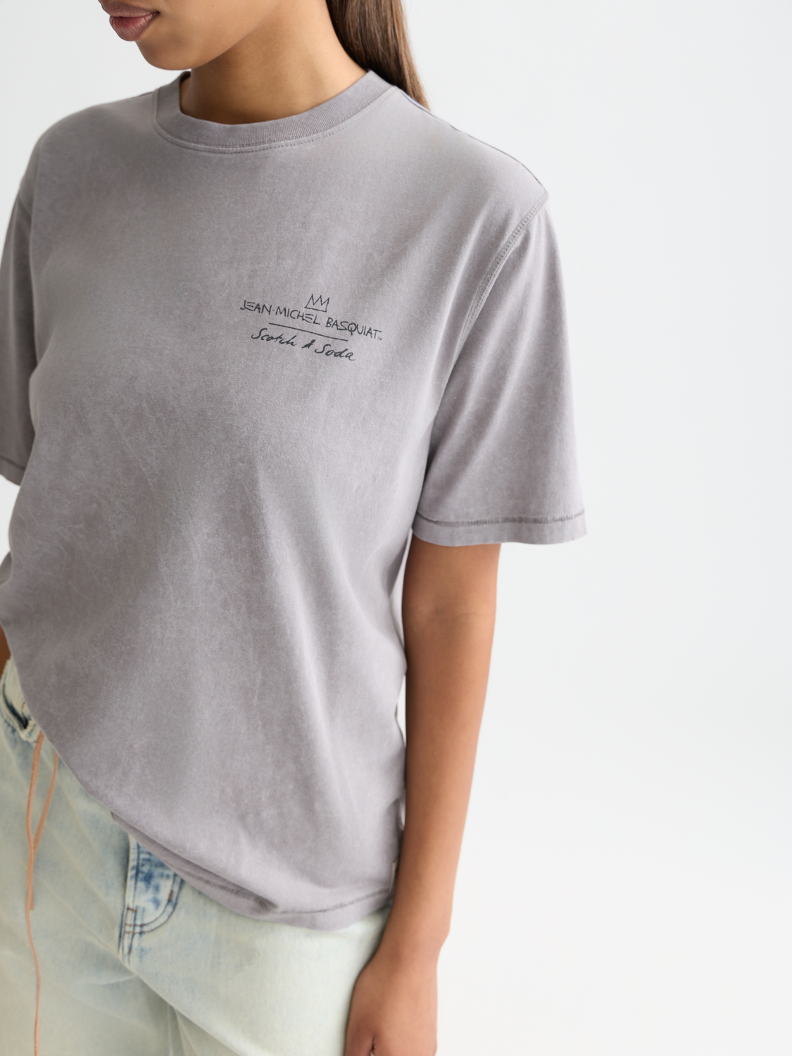 Short-sleeve S&S x Basquiat artwork t-shirt by Scotch & Soda featuring a colorful abstract graphic on soft cotton fabric.