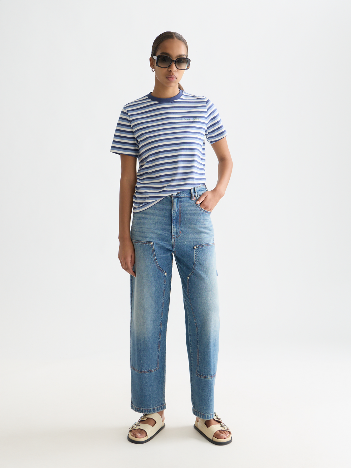Striped Scotch & Soda short-sleeve t-shirt with vertical blue and white stripes, displayed on a neutral background.