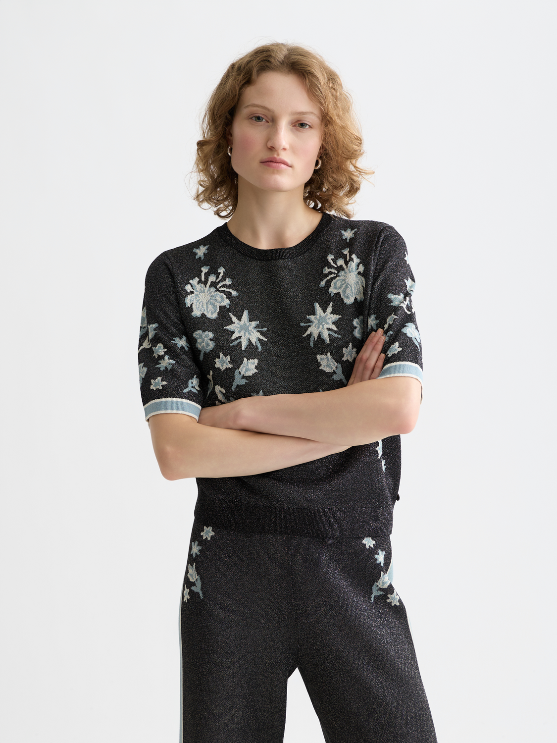Knitted short-sleeved jacquard top by Scotch & Soda featuring intricate patterns and a fitted silhouette.