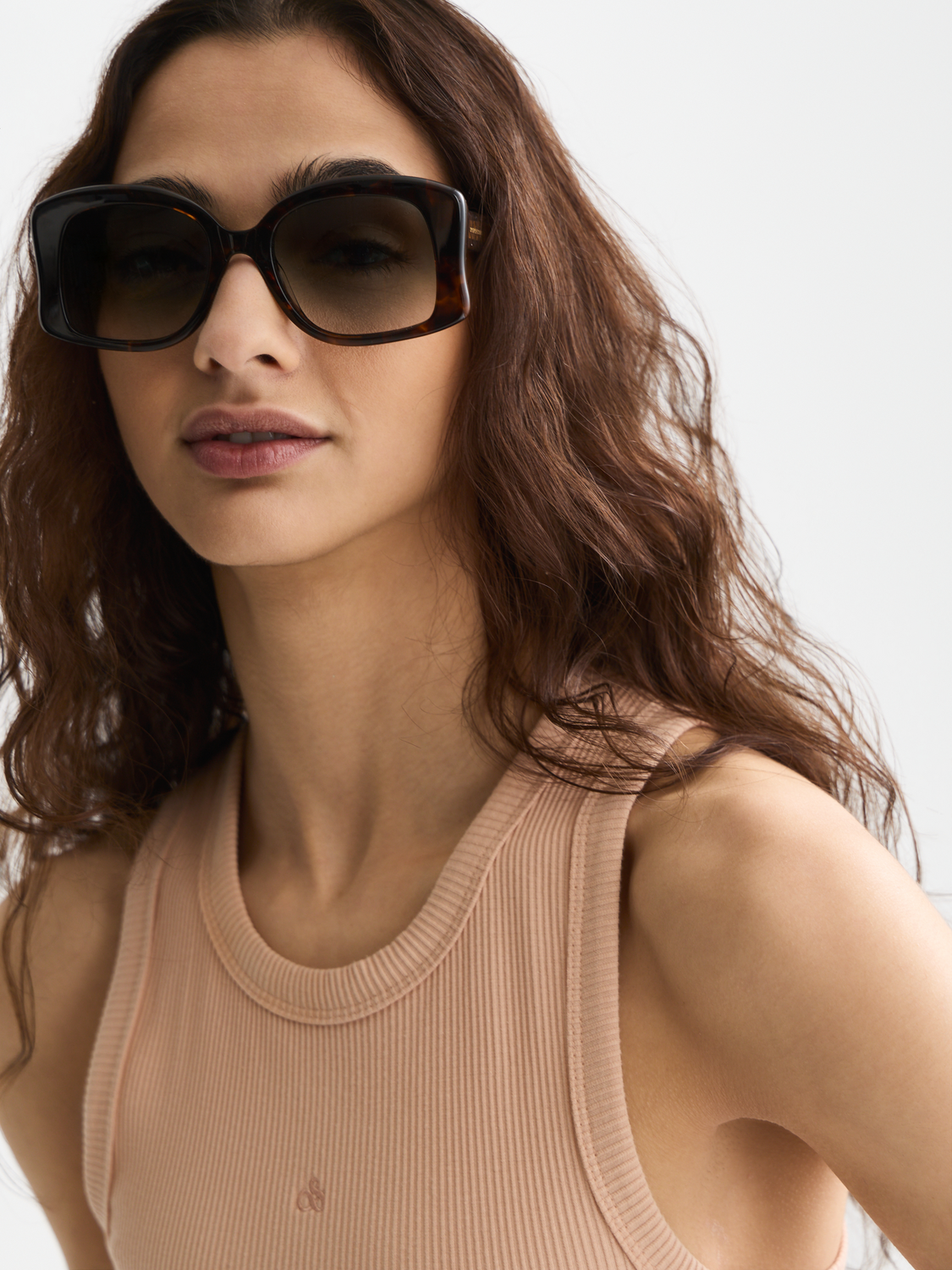Black Scotch & Soda rib racer tank top with sleeveless design and fitted style, shown on a model.