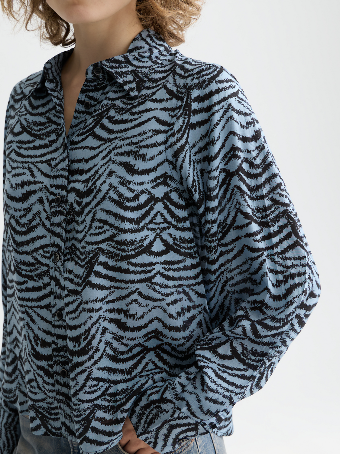 Long-sleeve printed shirt by Scotch & Soda featuring vibrant patterns and casual fit, displayed on a model.