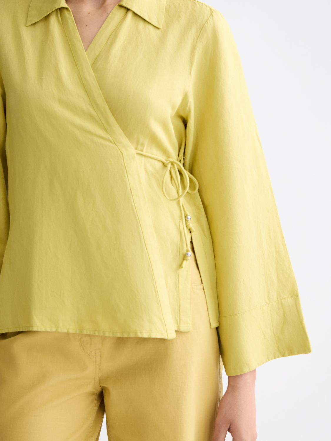 Long-sleeve Scotch & Soda wrap shirt with a stylish button-up design and soft fabric, shown on a model.