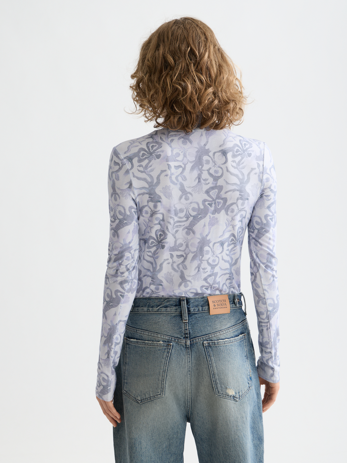 Long sleeve printed mock neck tee from SCOTCH & SODA, featuring a stylish design in a close-up view.