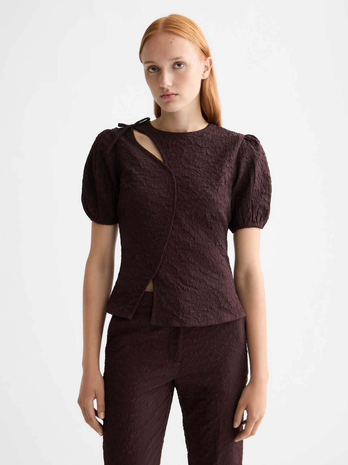 Woven top with puff sleeves from Scotch & Soda, featuring textured fabric and a front detail against a neutral background.