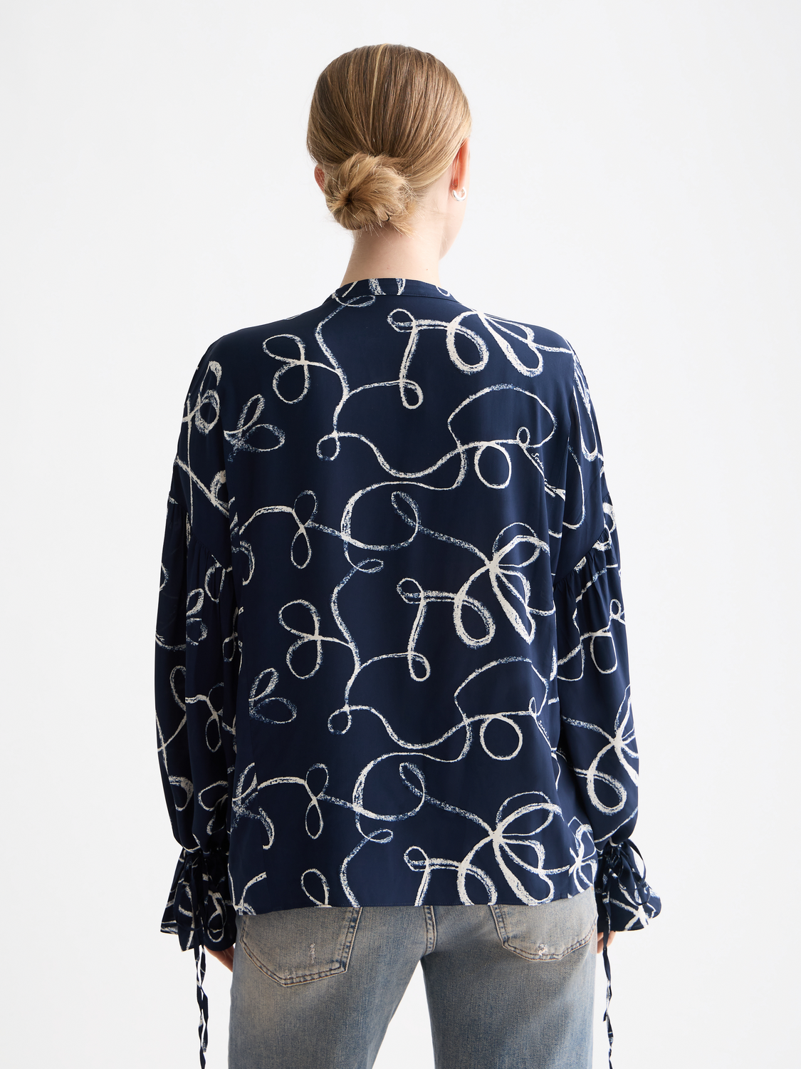 Woven Scotch & Soda draw string blouse with relaxed fit, long sleeves, and button-up front, shown in black fabric.