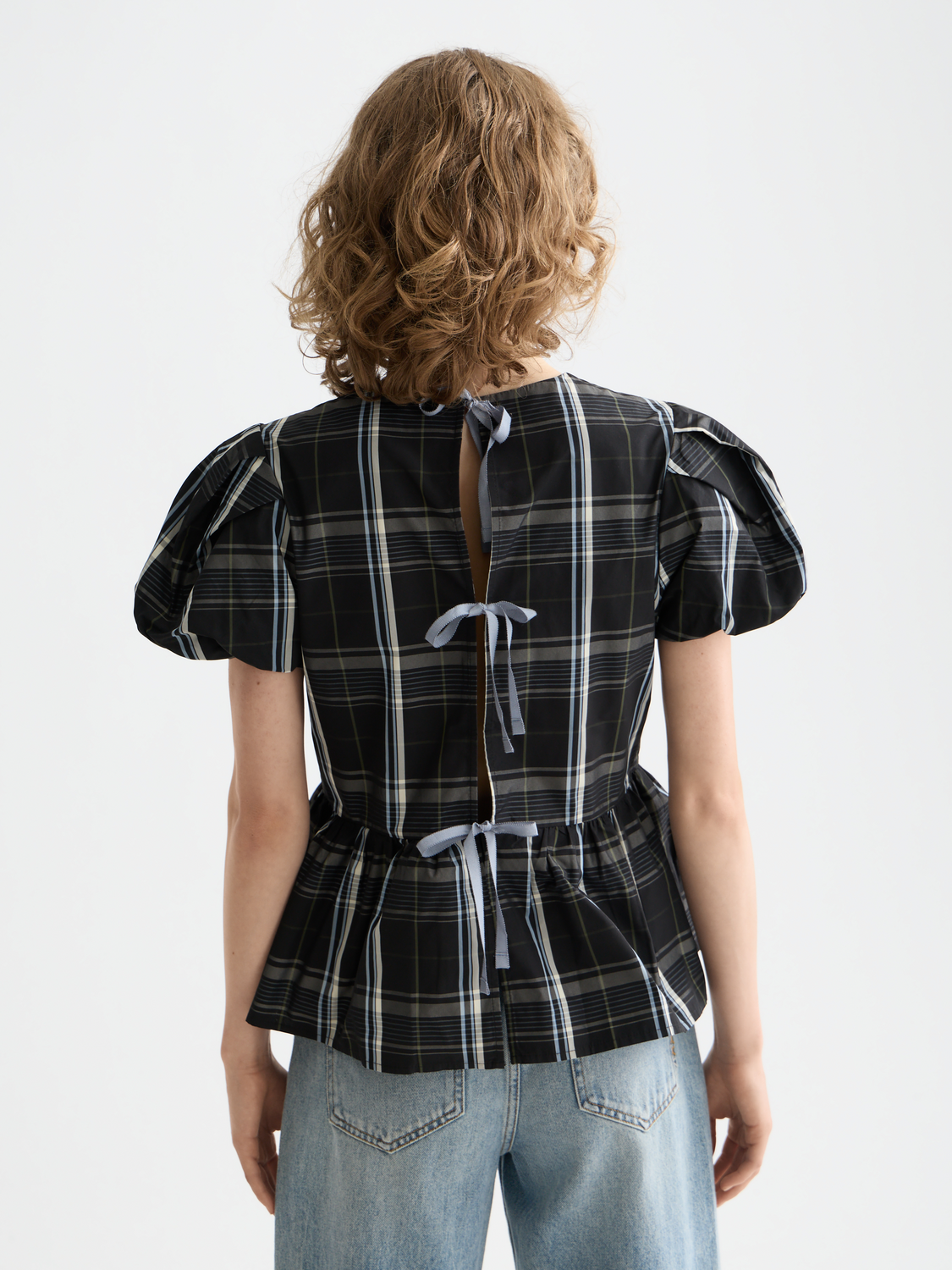 Black woven taffeta peplum top by Scotch & Soda featuring a fitted bodice and ruffled peplum detail.