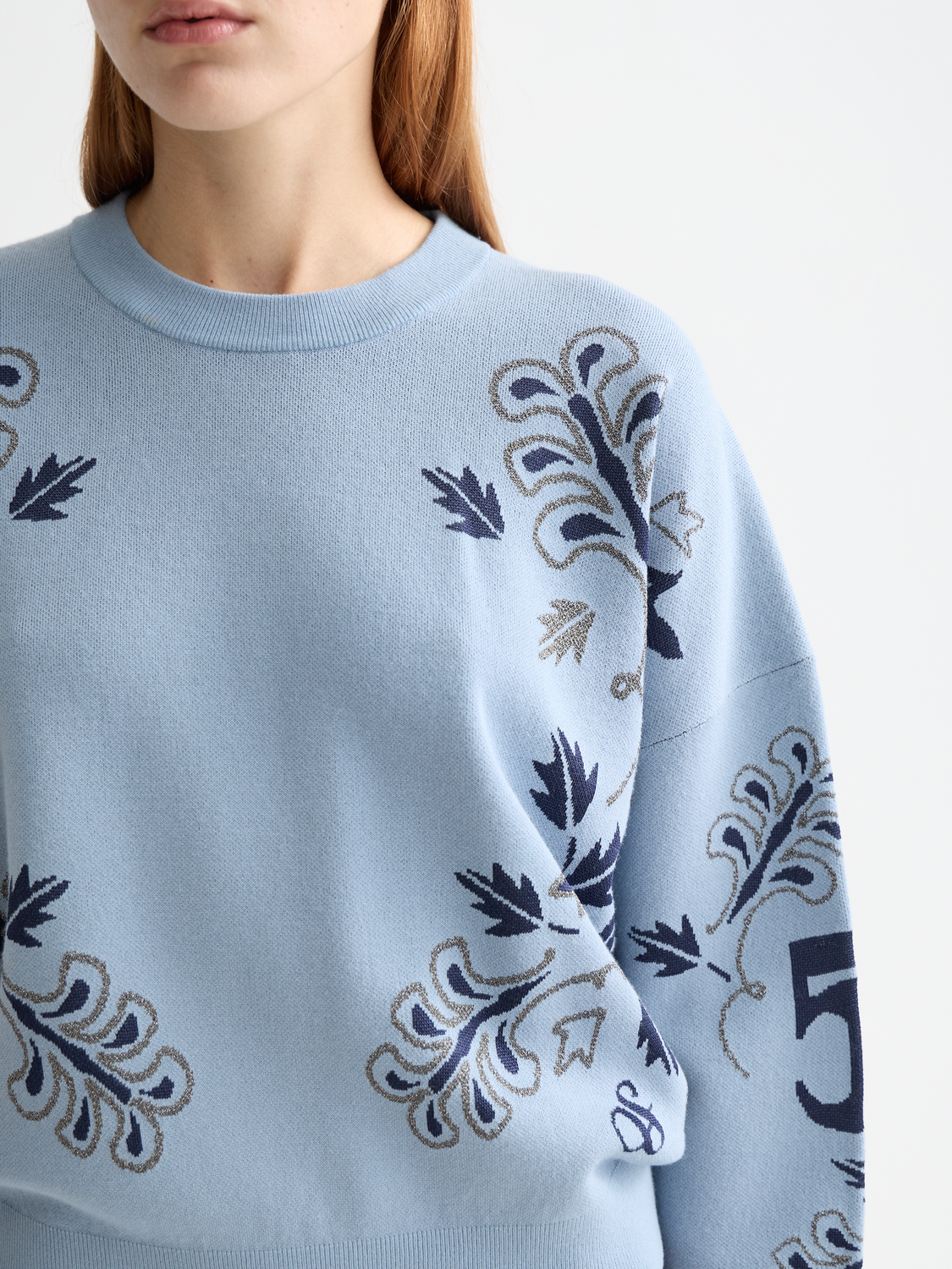 Scotch & Soda jacquard knit pullover featuring intricate patterns and a cozy fit, displayed on a neutral background.