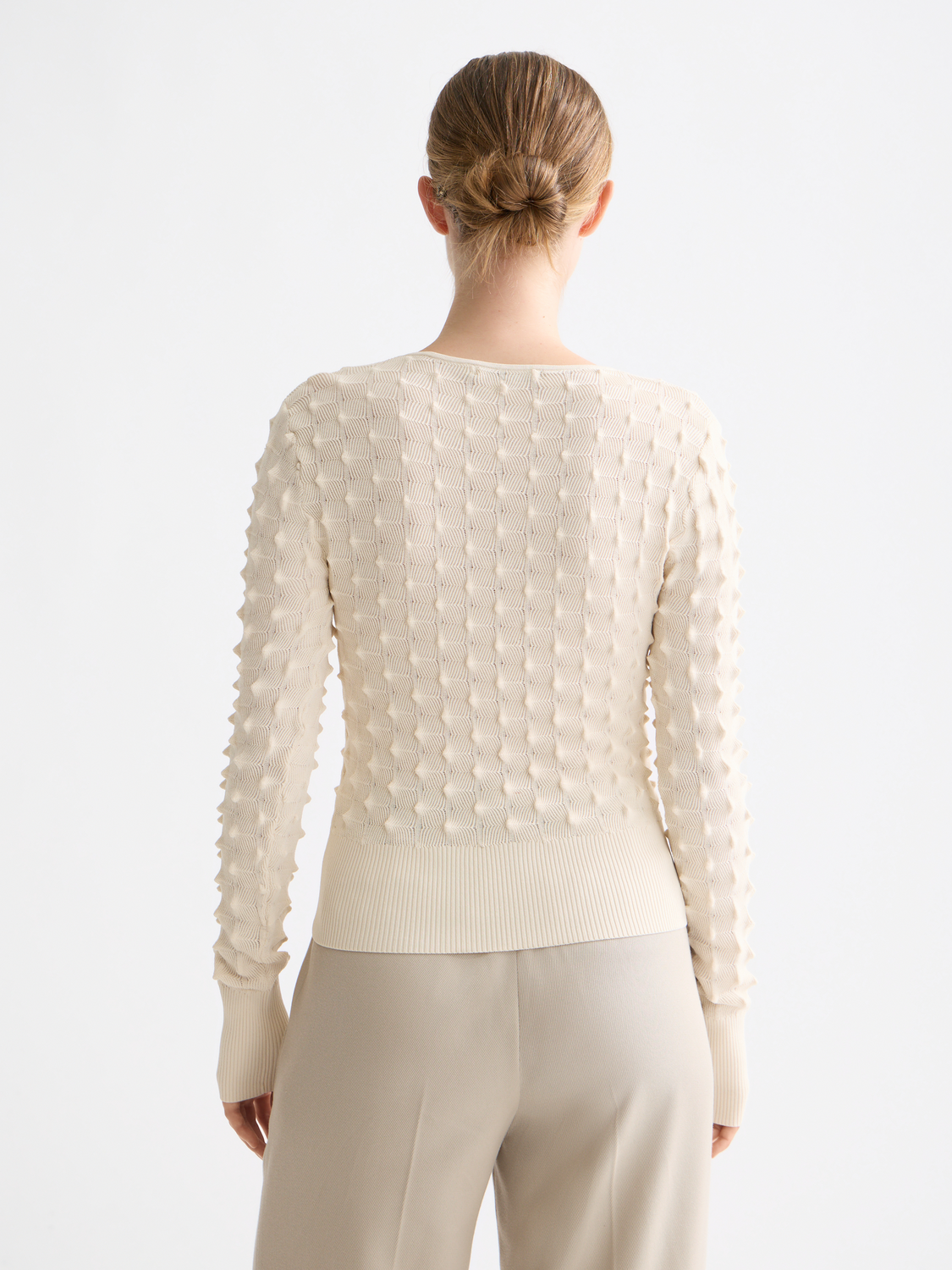 Textured stitch knitwear pullover by Scotch & Soda, showing close-up of fabric and detailed stitching on the back.