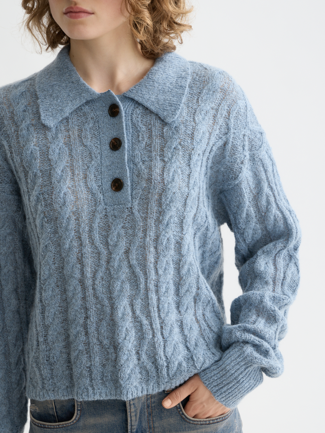 Cable stitch knitwear polo pullover by Scotch & Soda, featuring a classic collar and textured cable pattern in a casual style.