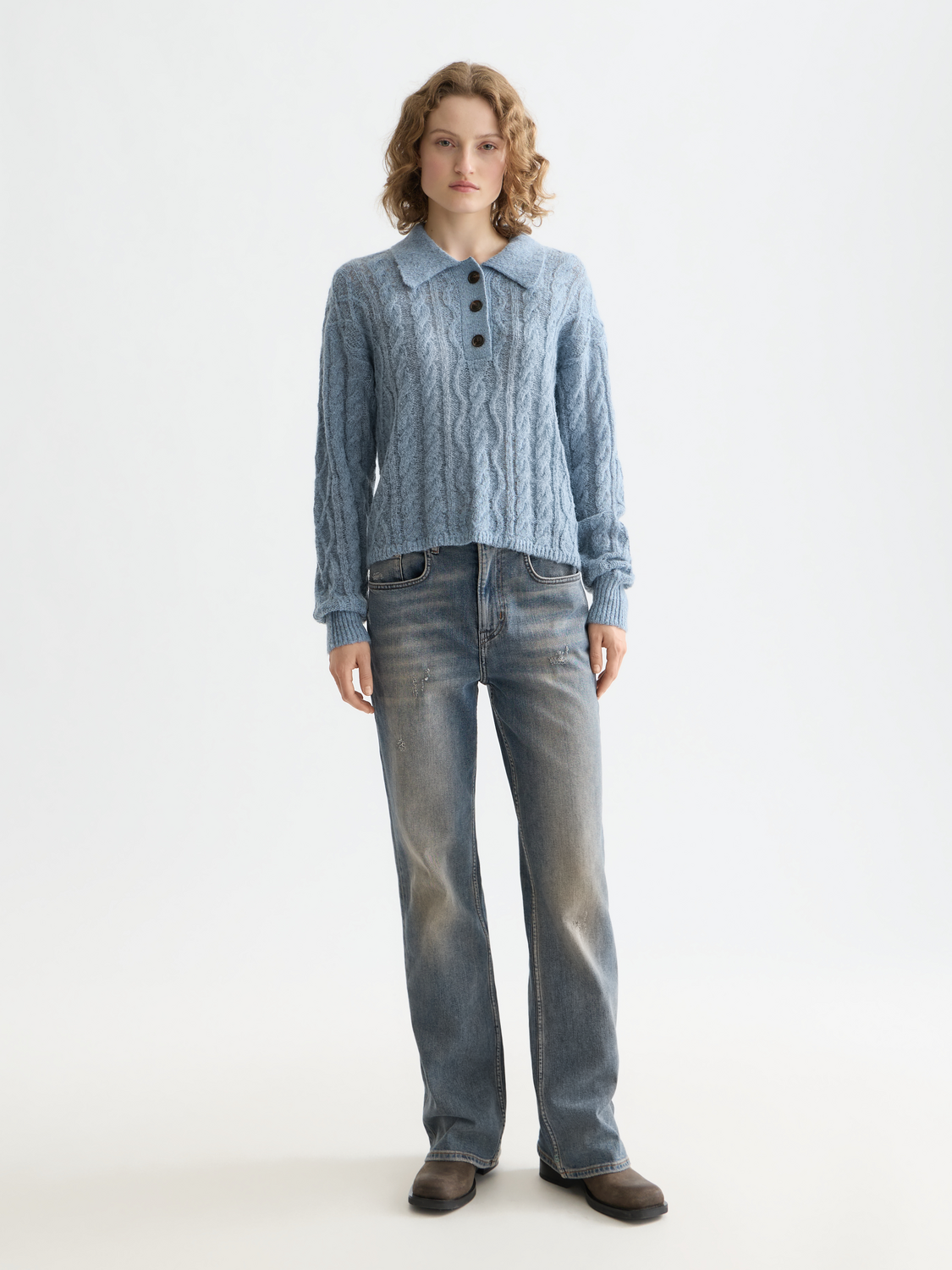 Scotch & Soda cable stitch polo pullover in knitwear with a classic collar and textured cable pattern, front view.