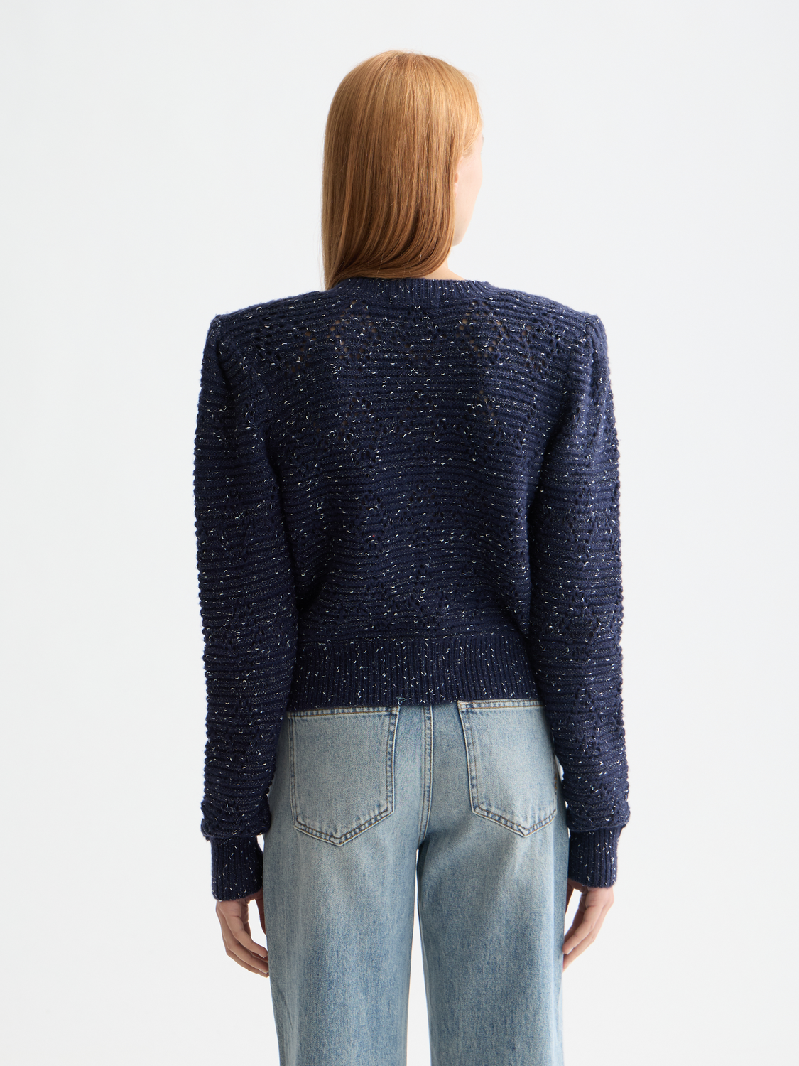Metallic crewneck cardigan by Scotch & Soda, showing the knitwear with a shiny metallic finish and ribbed cuffs on a neutral background.