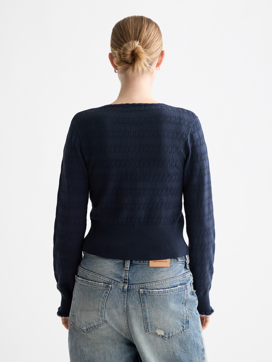 Pointelle knitted cardigan by Scotch & Soda featuring delicate openwork patterns, long sleeves, and a cozy knit texture.