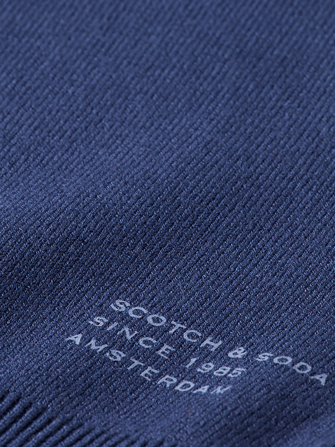 Relaxed-fit V-neck knitwear pullover by Scotch & Soda, showing soft fabric and casual style in natural light.