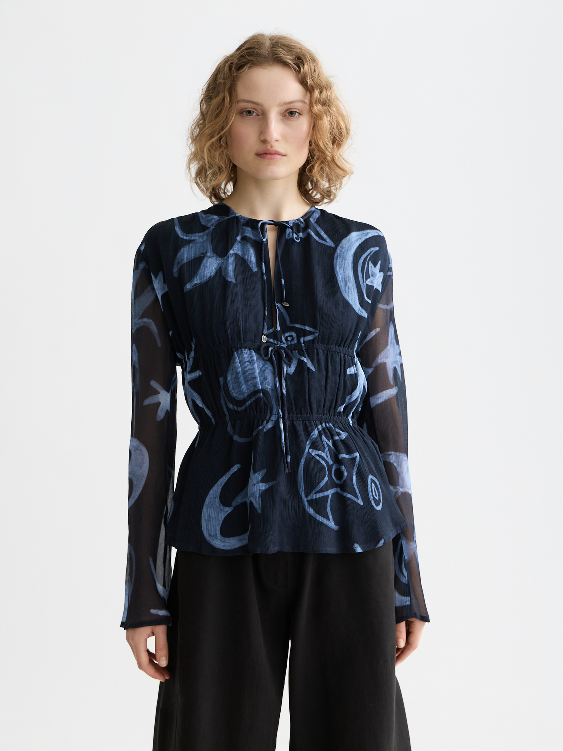 Printed woven top with tie front from Scotch & Soda, shown in a close-up image highlighting the fabric and design details.