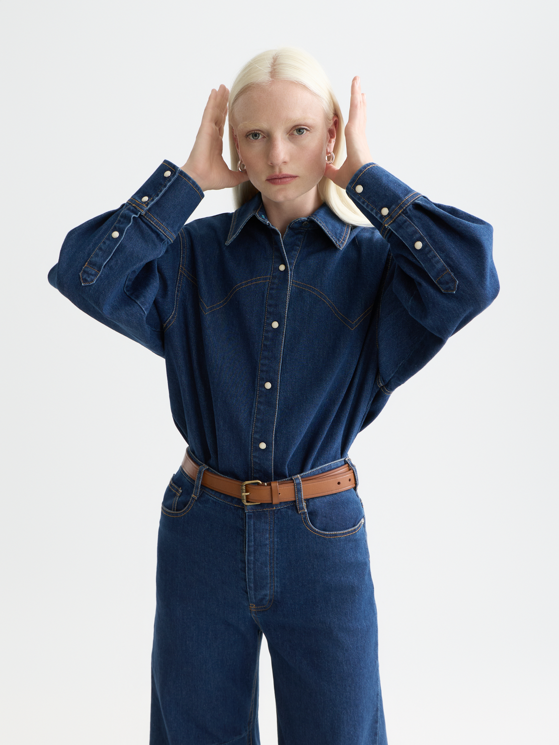 Long-sleeve denim shirt by Scotch & Soda, featuring classic button front and chest pockets, shown in a casual front view.
