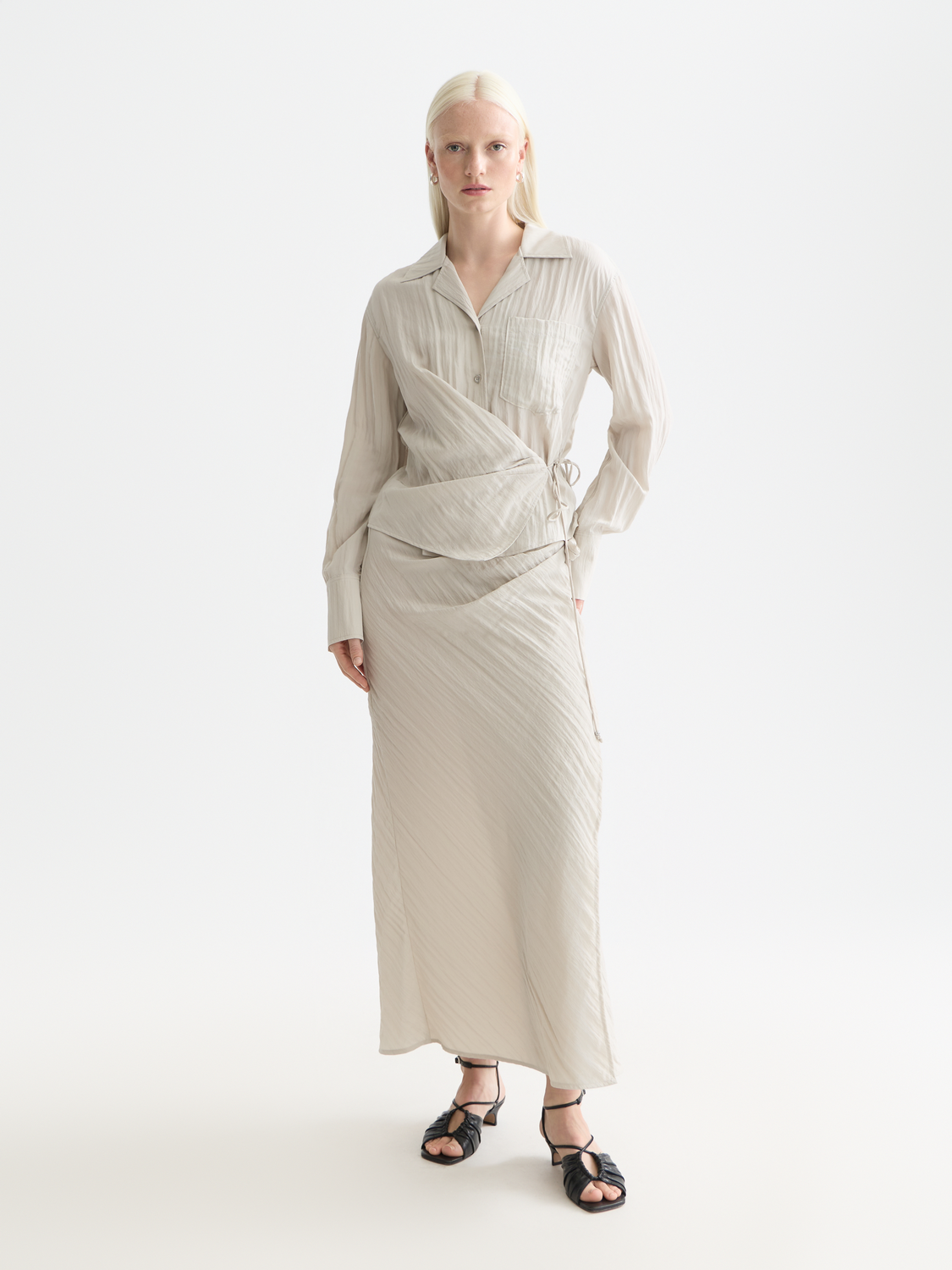 Long sleeve wrap shirt by Scotch & Soda featuring a stylish design, shown on a model with a buttoned front and cuffed sleeves.