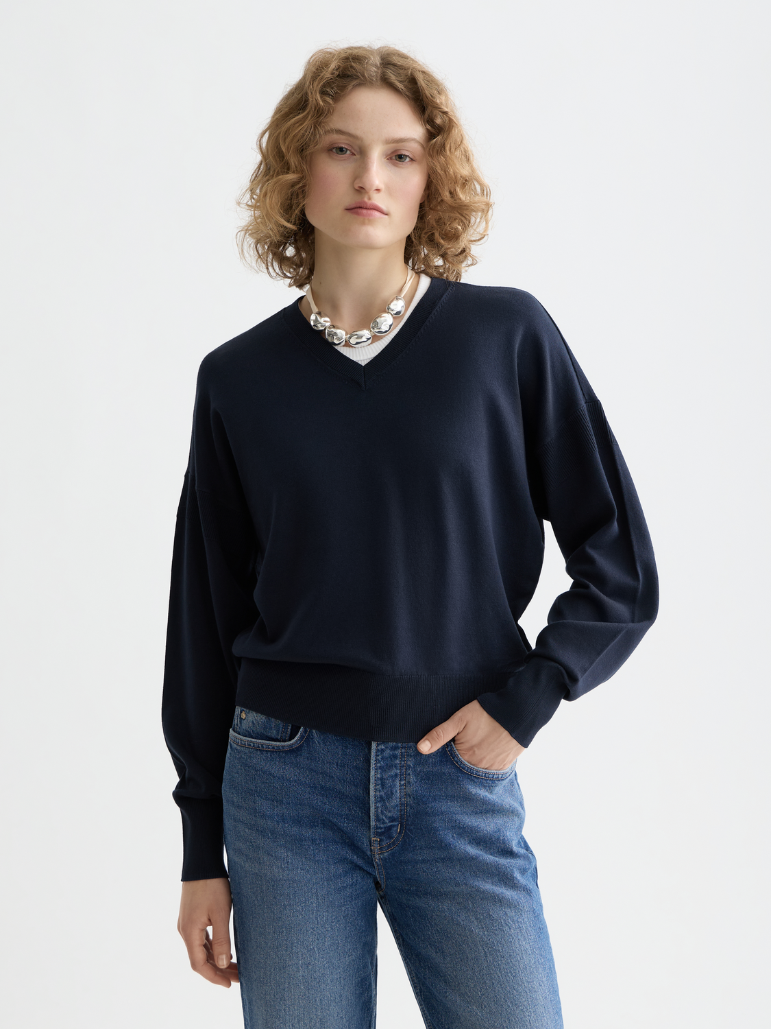Scarlet V-neck relaxed fit knitwear pullover by SCOTCH & SODA displayed on a model, featuring soft fabric and casual style.