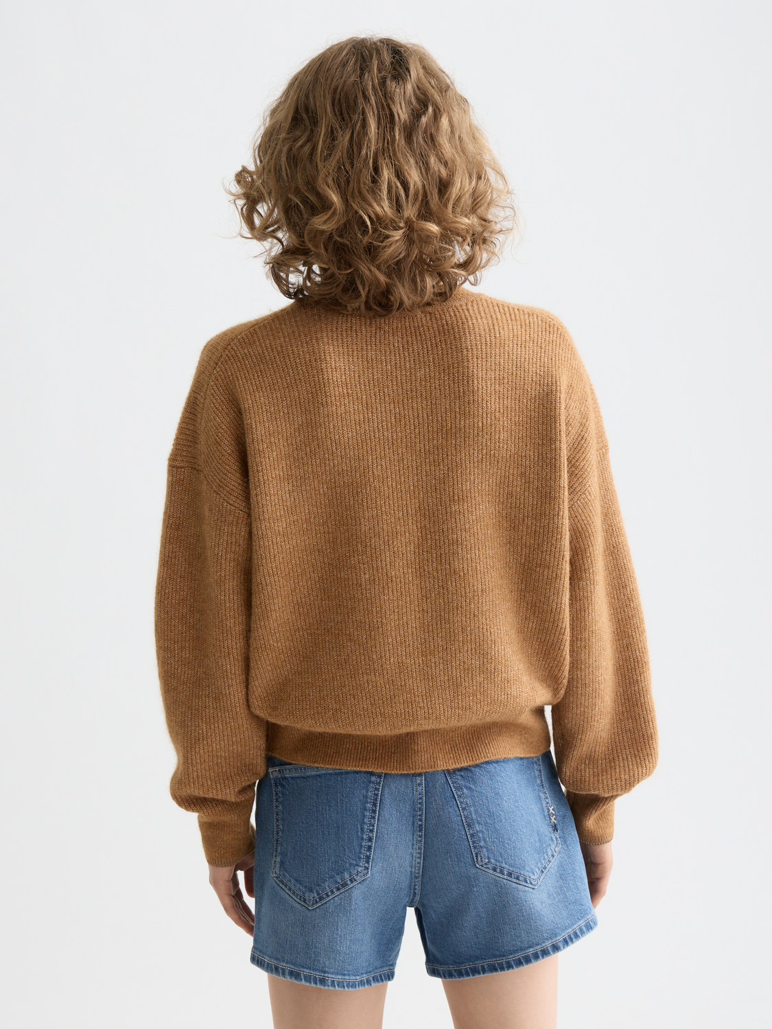 Back view of a Scotch & Soda crewneck knitwear pullover in a cozy, textured fabric with ribbed cuffs and hem.