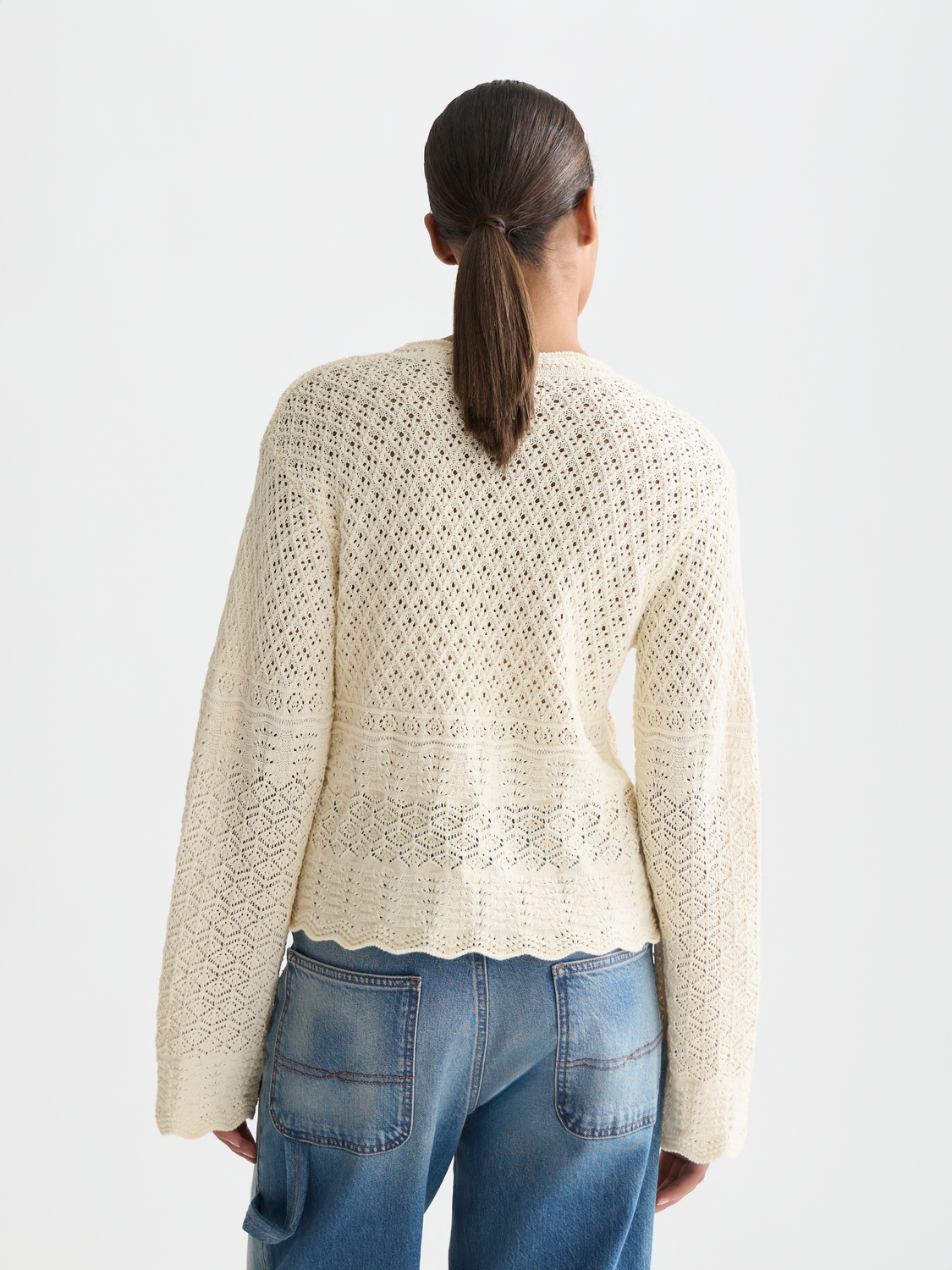 Pointelle v-neck knitwear pullover by Scotch & Soda, showing the back view with intricate knit pattern and relaxed fit.