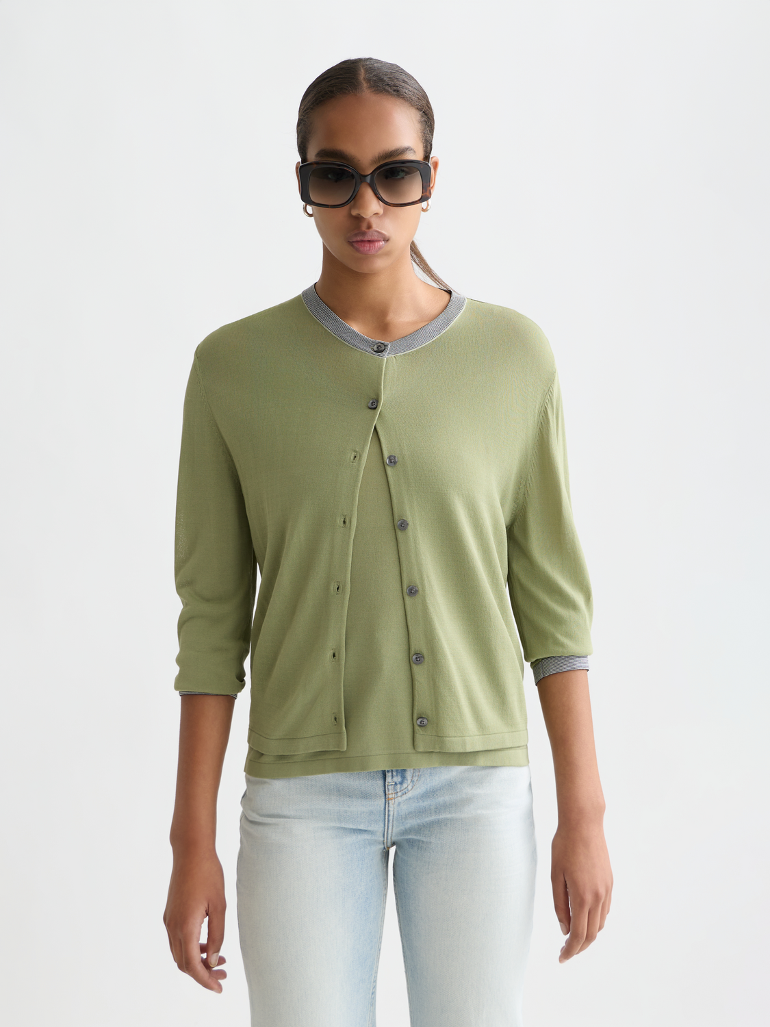 Cream crewneck cardigan by Scotch & Soda, featuring a cozy knitwear design with button details and ribbed cuffs.