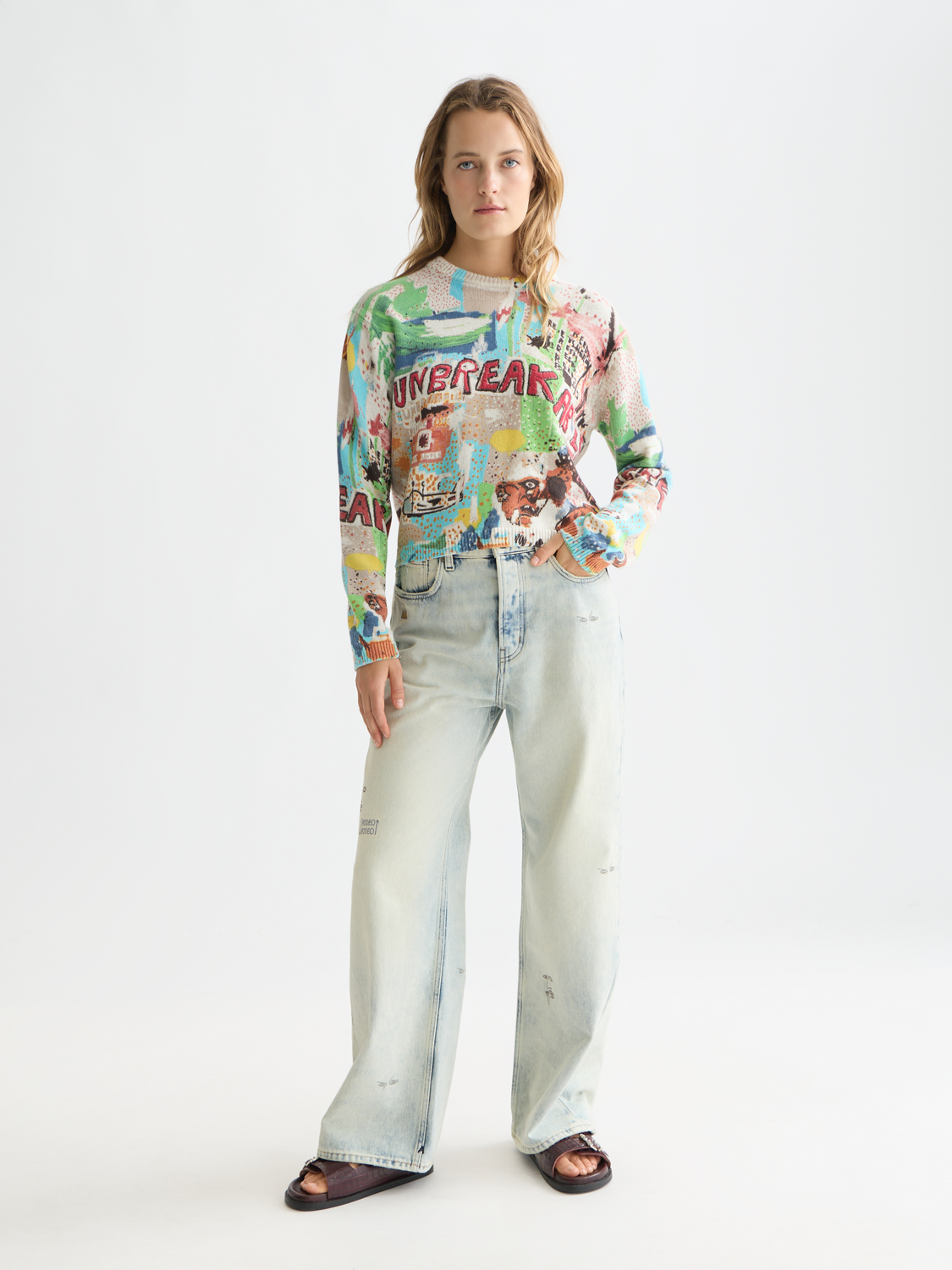 Scotch & SODA S&S x Basquiat printed knitwear pullover featuring colorful Basquiat artwork on a cozy sweater.