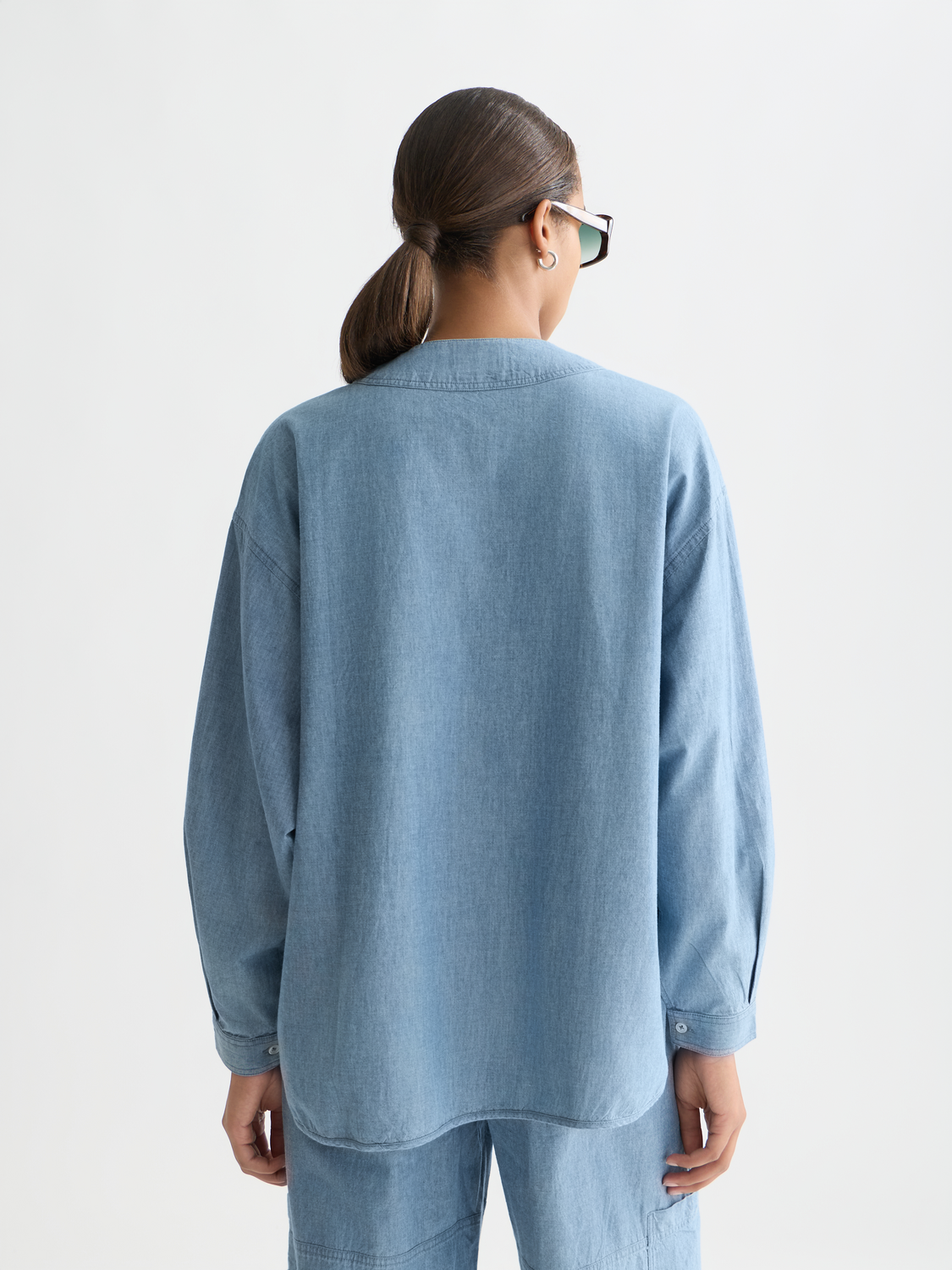 Denim bib shirt woven top by Scotch & Soda, featuring a front bib design and back view in a casual denim style.