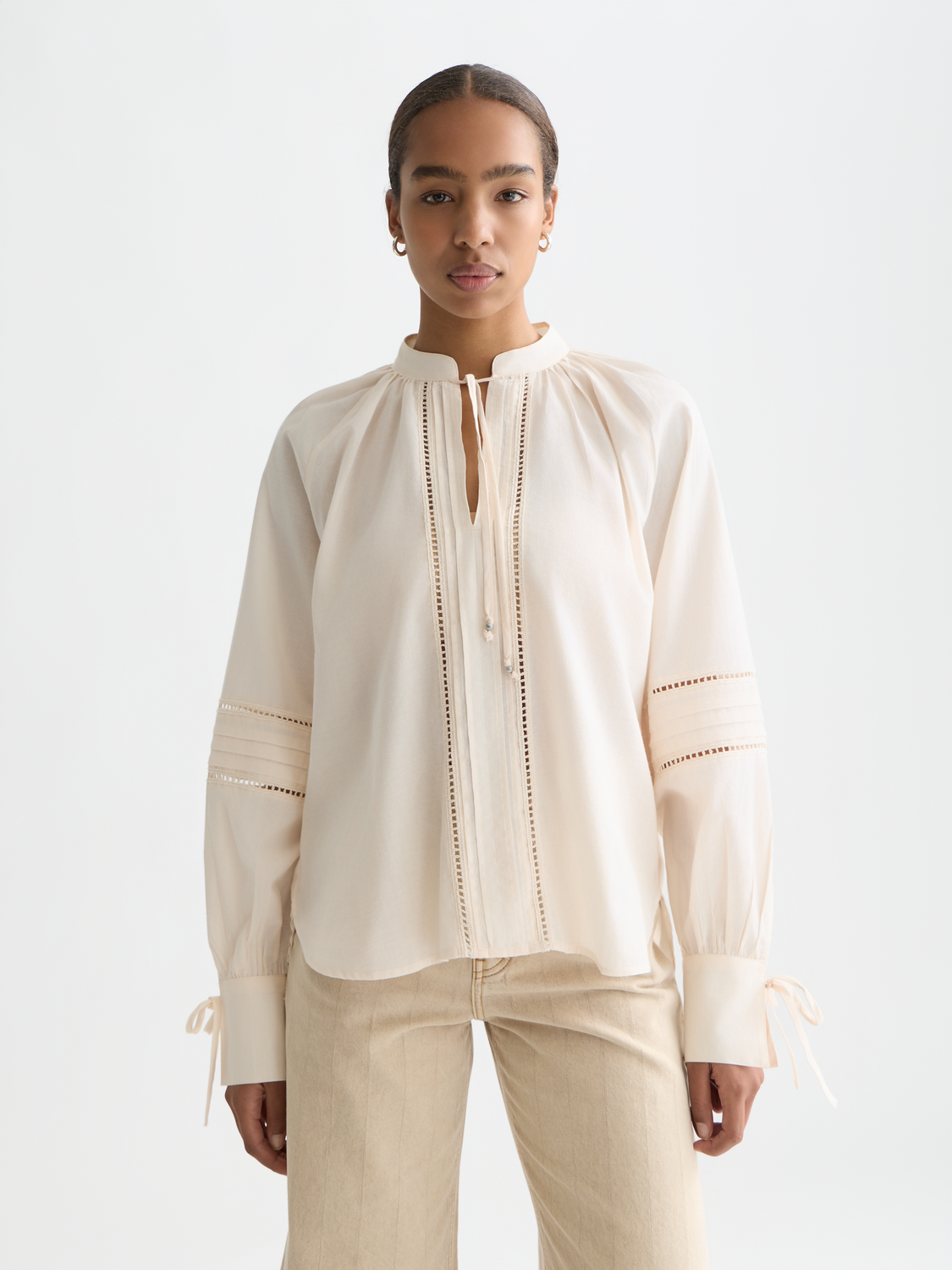 Scotch & Soda pleated woven blouse with long sleeves and a round neckline, showcasing a stylish, lightweight fabric design.