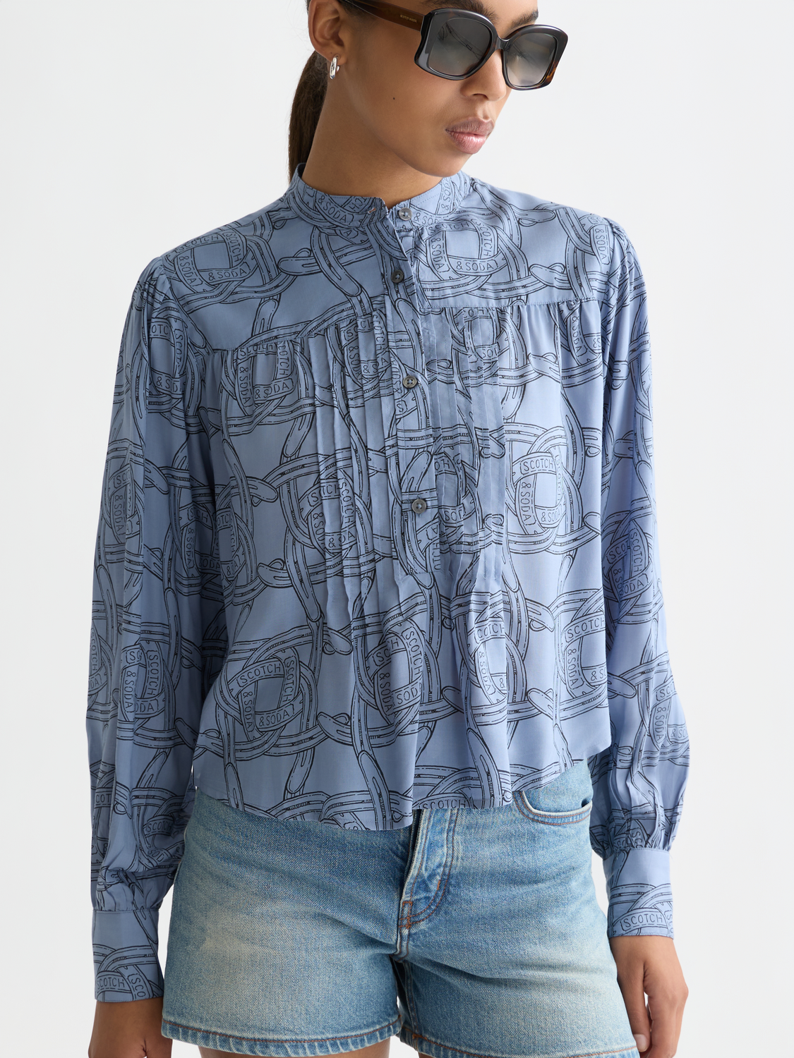 Long-sleeve Scotch & Soda pintuck shirt with button front and tailored fit, shown in a stylish, casual setting.