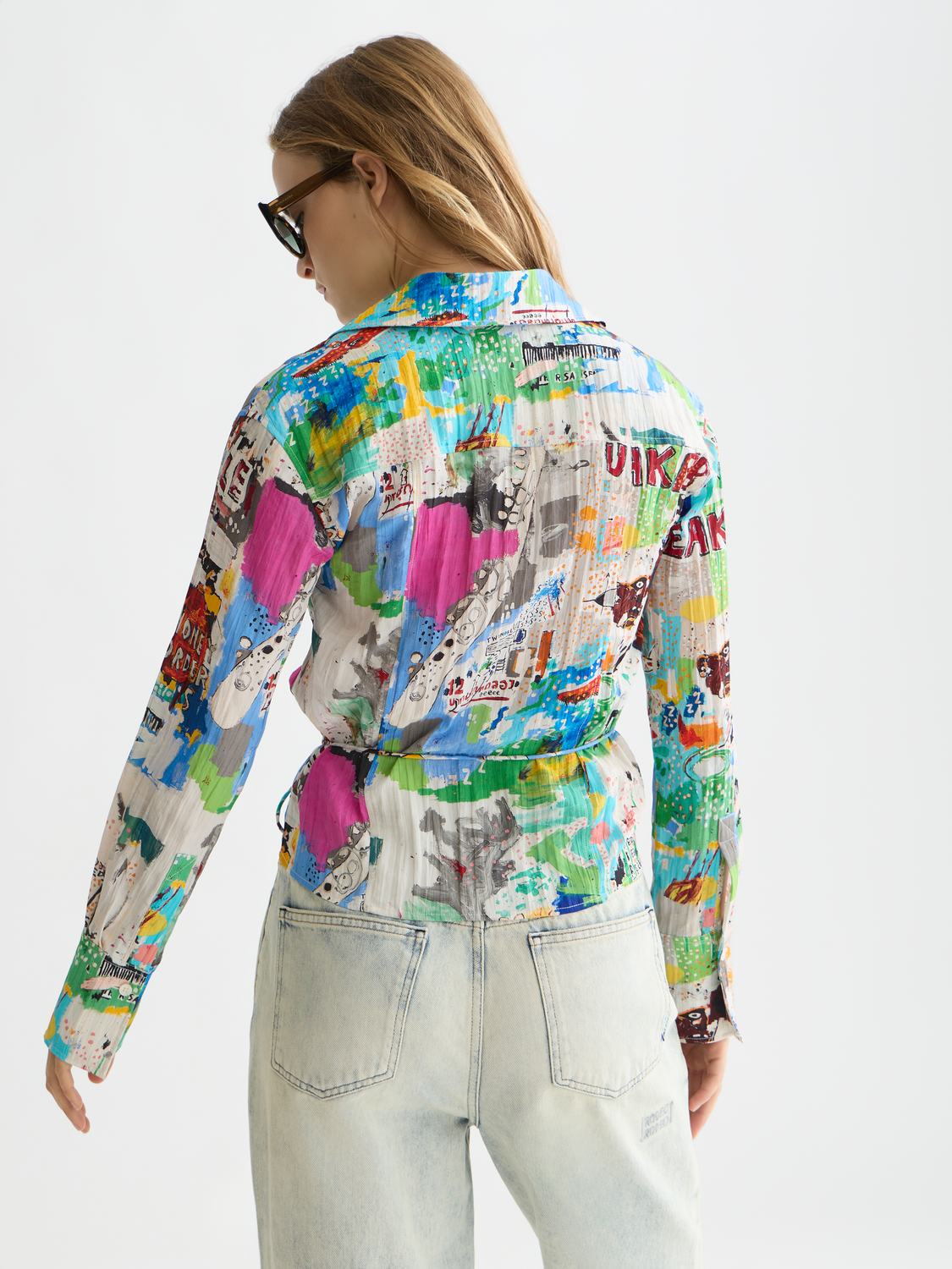 Long-sleeved SCOTCH & SODA shirt featuring S&S x Basquiat artwork, shown from the back with a bold graphic design.
