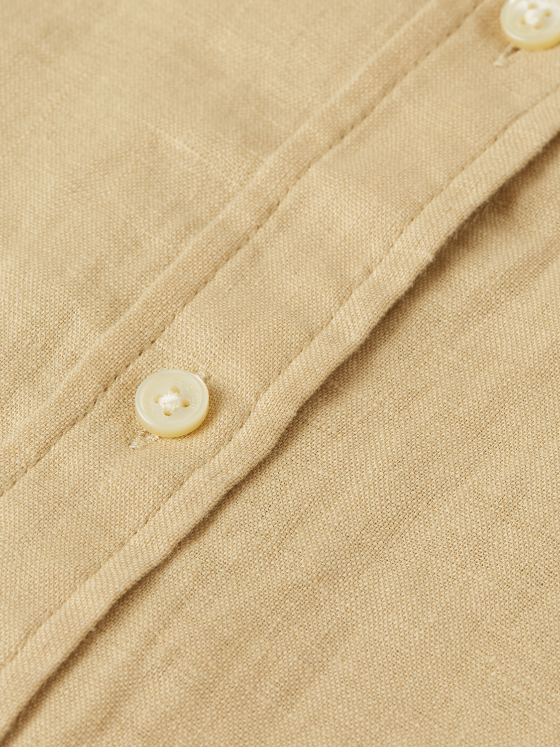 Long-sleeve Scotch & Soda linen shirt displayed on a hanger, showcasing its lightweight, breathable fabric and classic design.