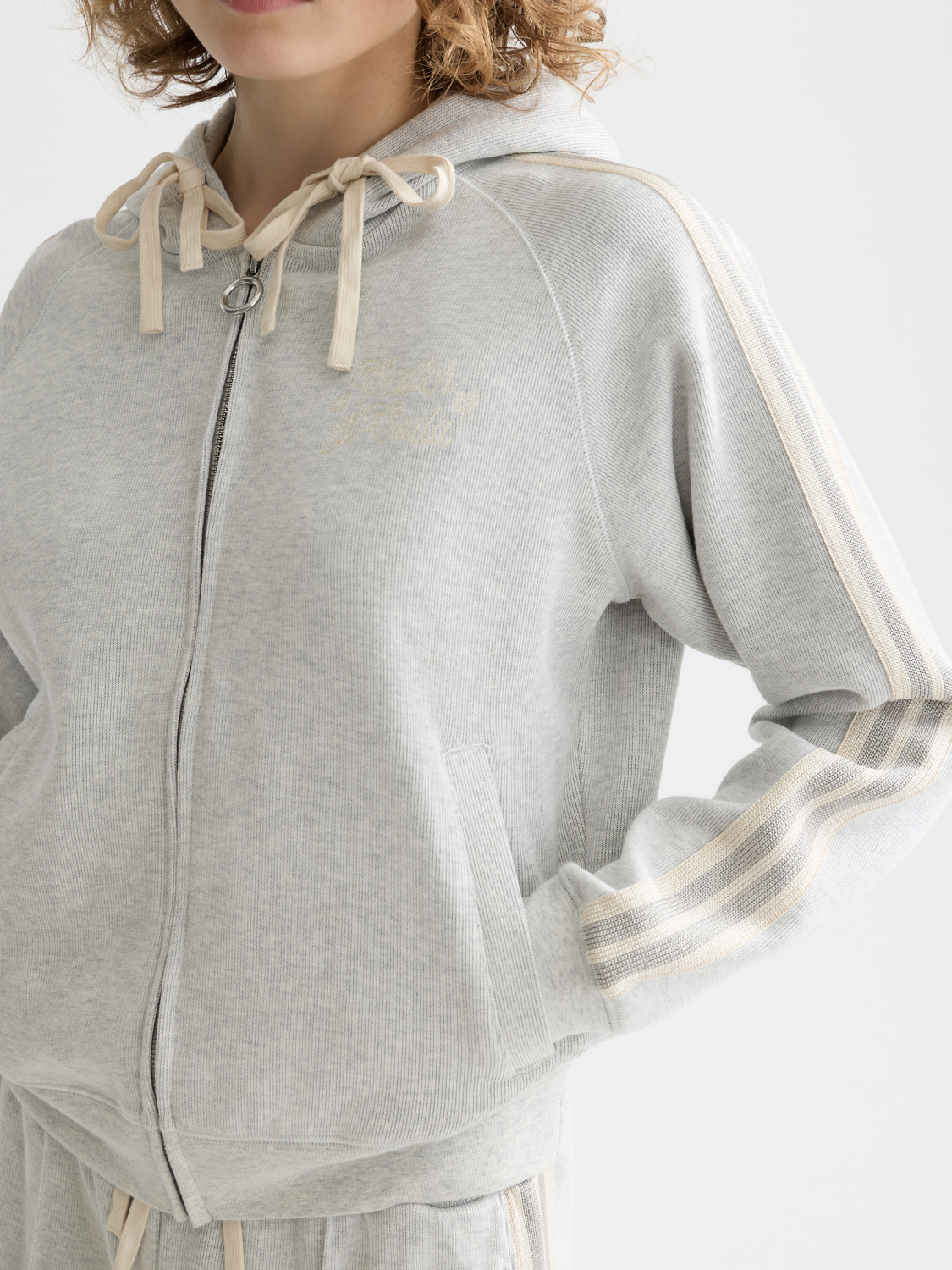Gray zip-through hoodie from Scotch & Soda, casual sweat with a front zipper and comfortable fit, shown on a model.