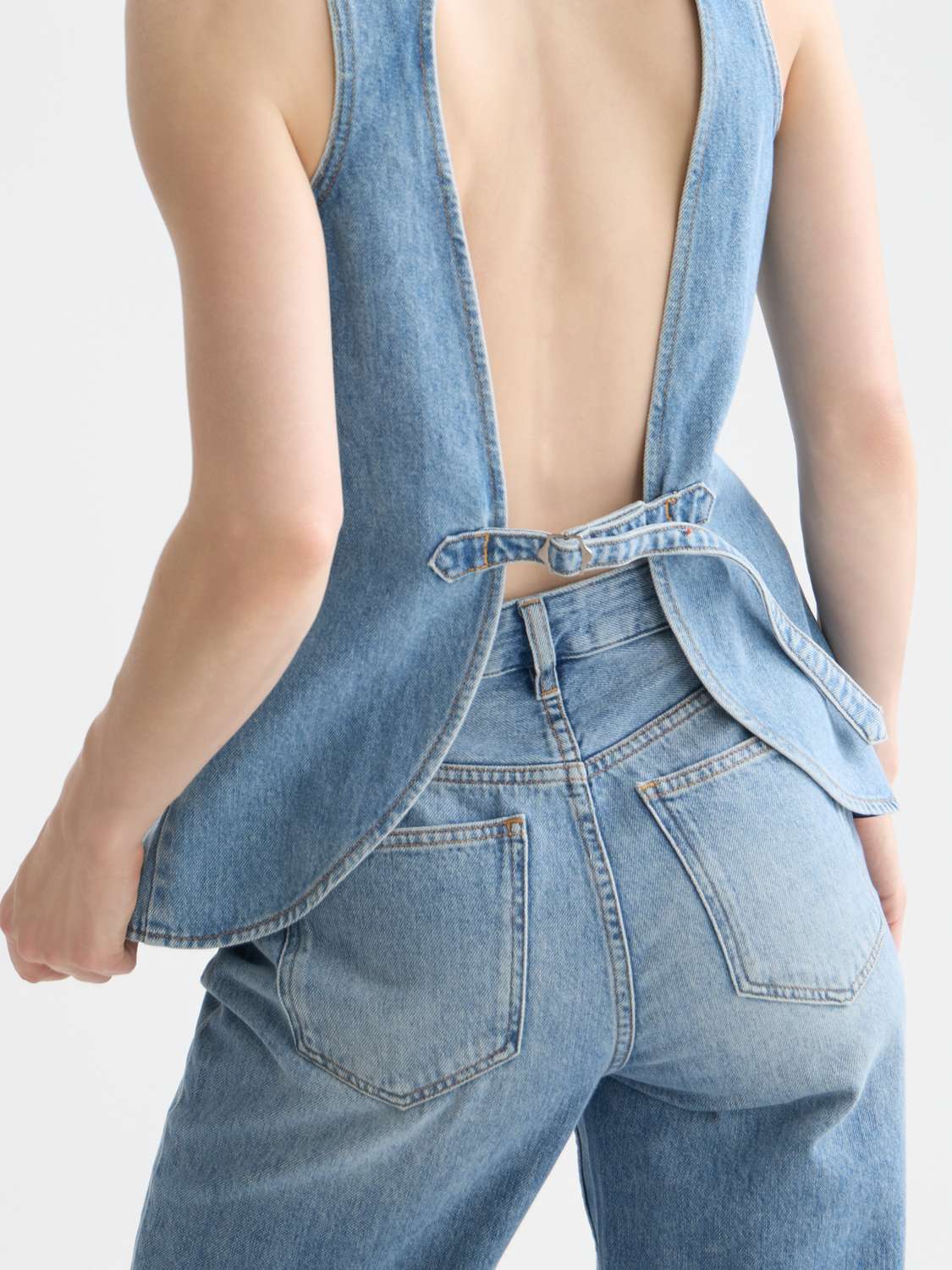 Western denim gilet by Scotch & Soda featuring a sleeveless design with button closure and classic denim texture.