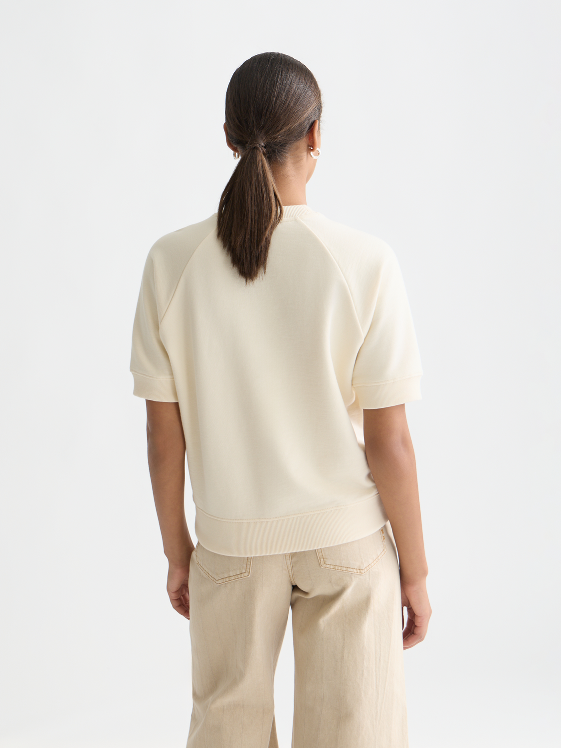 Short-sleeved artwork sweatshirt by Scotch & Soda with colorful printed design on front, displayed from the back view.