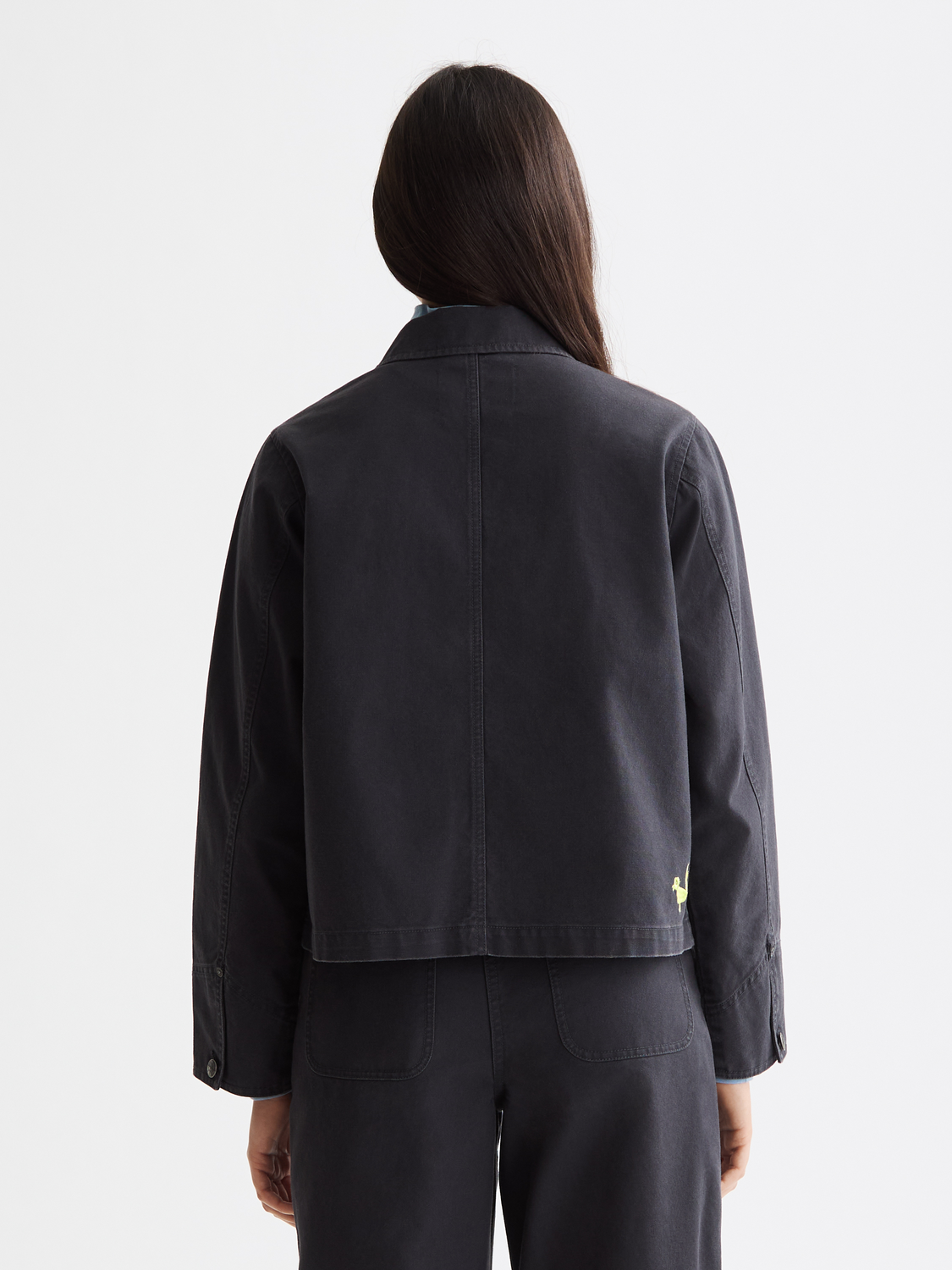 Washed workwear jacket by Scotch & Soda, shown from the back with a relaxed fit and durable fabric for casual or workwear style.