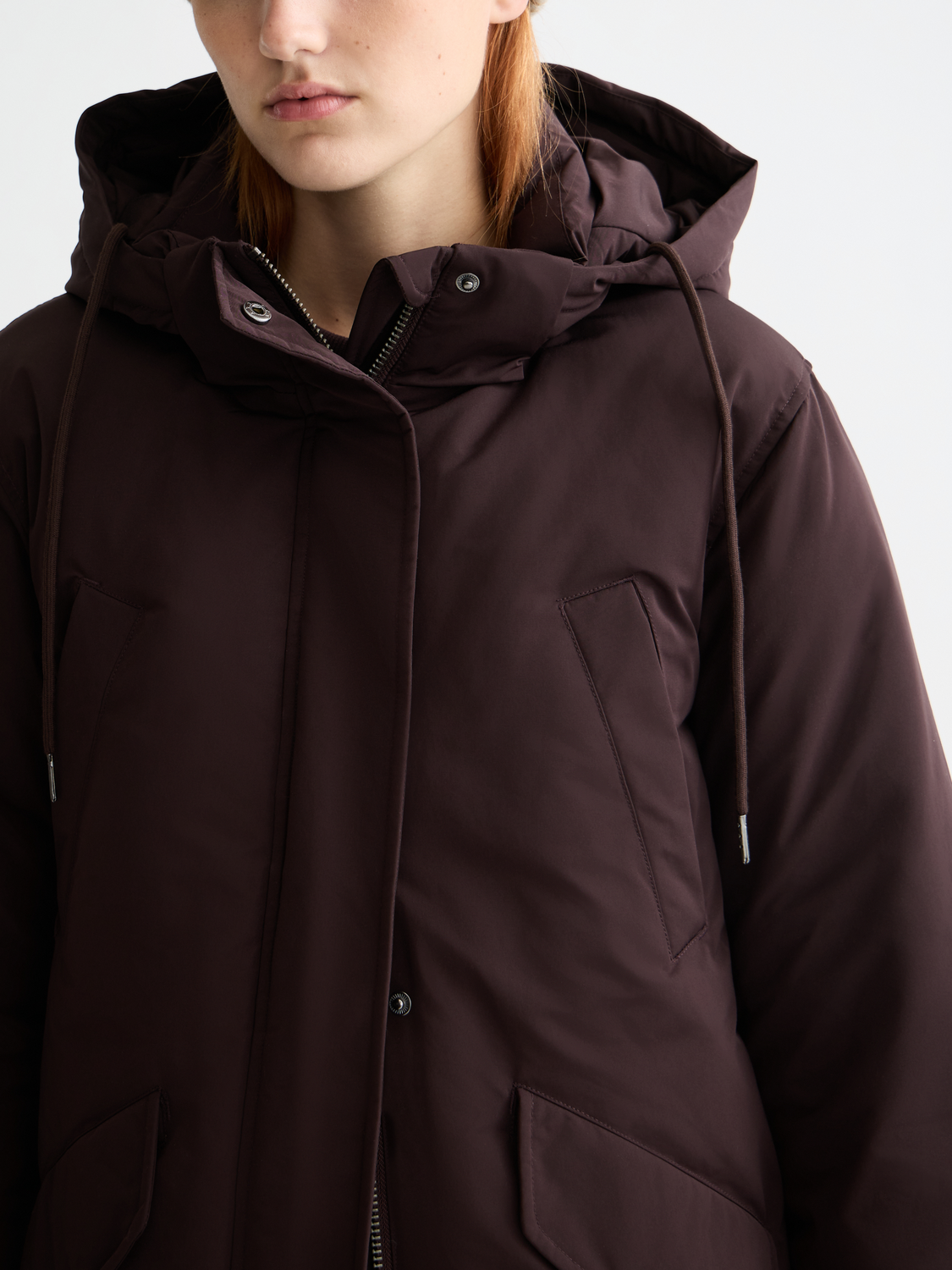 City parka jacket by Scotch & Soda, shown in dark color with hood, front zipper, and side pockets for casual urban style.