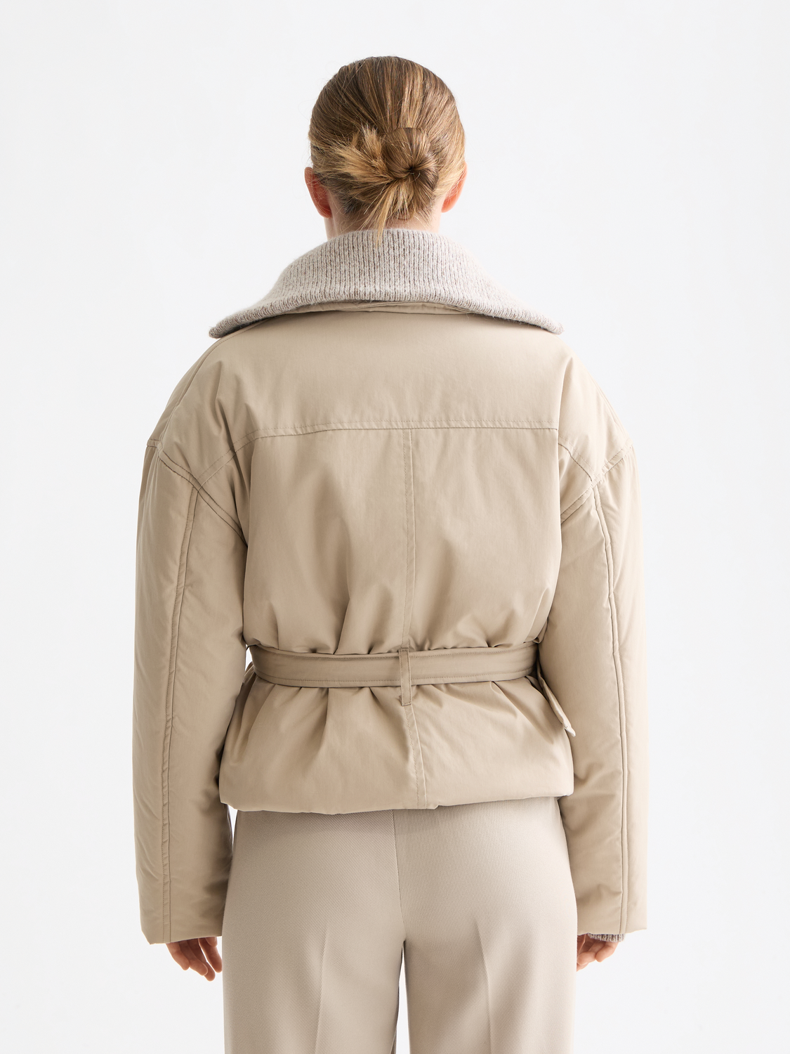 Padded cropped trench coat by SCOTCH & SODA, stylish jacket with a fitted silhouette and padded design, shown from the back.