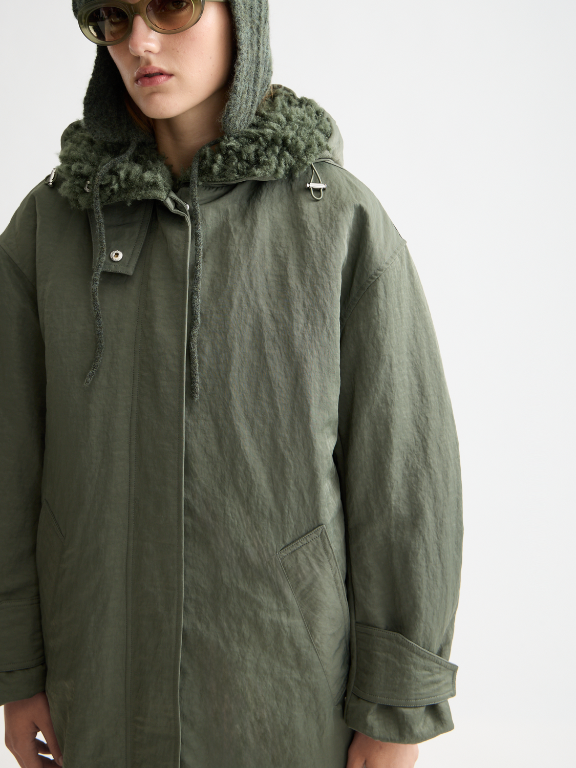 Two-in-one Scotch & Soda parka jacket with removable inner layer and adjustable hood, shown on a model.