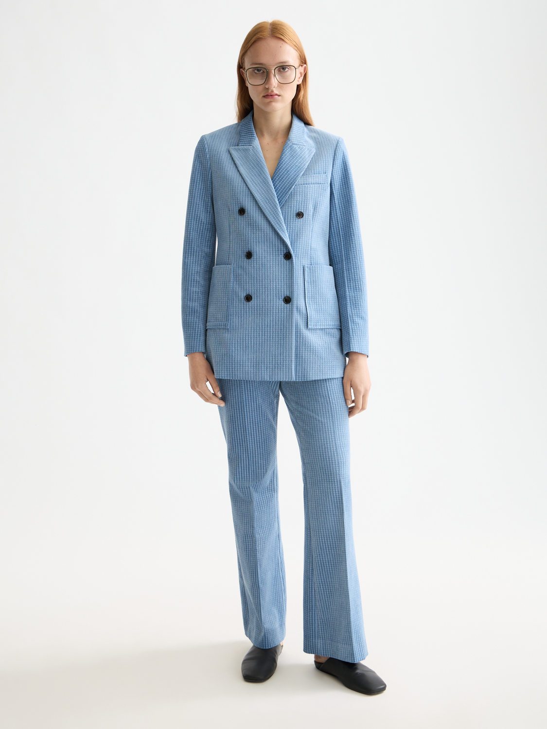 Navy corduroy blazer by Scotch & Soda, tailored fit with notch lapel and front pockets, worn by a model.