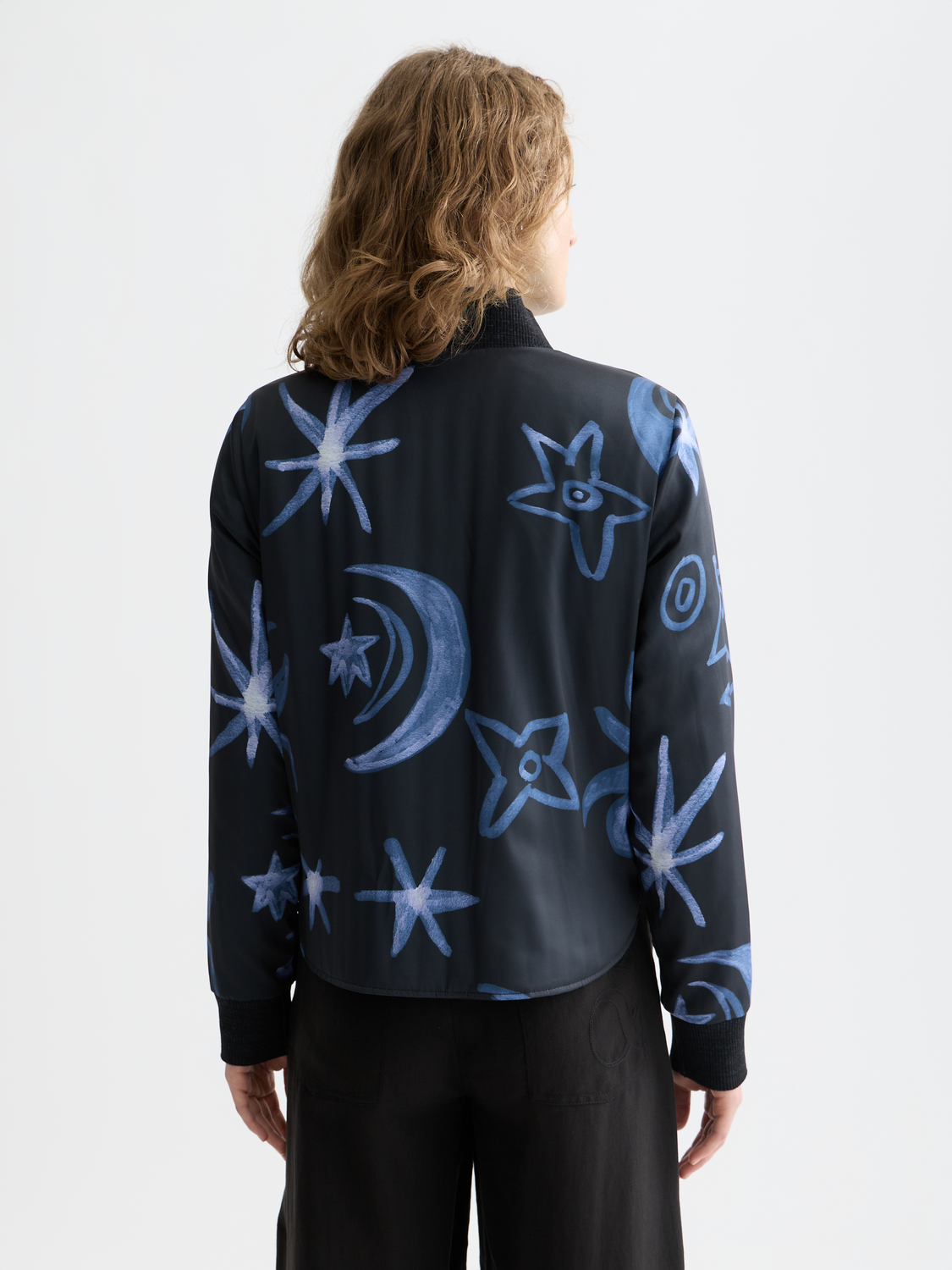 Reversible quilted bomber jacket by Scotch & Soda featuring a stylish design and quilted texture, displayed from the back view.