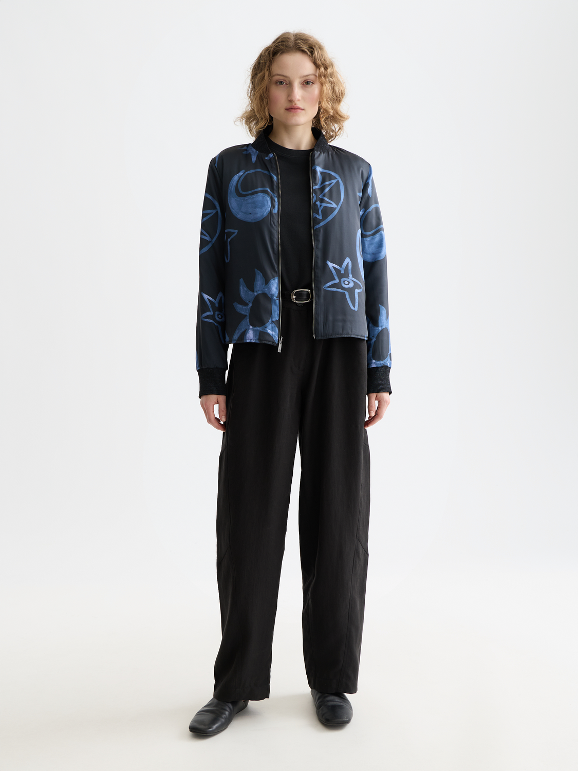 Reversible quilted bomber jacket by Scotch & Soda, showing both quilted and smooth fabric sides, front view.