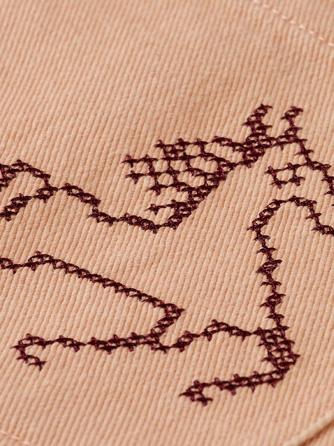 Embroidered SCOTCH & SODA jacket with intricate floral designs, shown on a hanger against a plain background.
