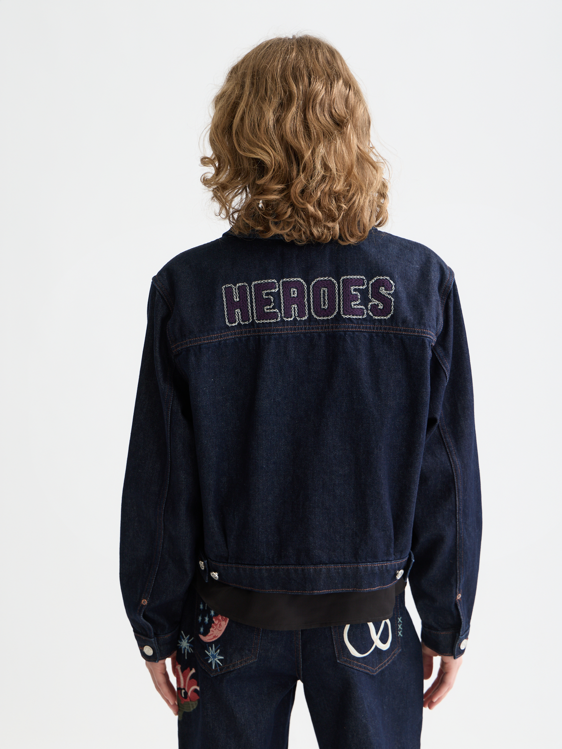 Embroidered denim jacket by Scotch & Soda, showing the back with colorful embroidery and classic denim fabric design.