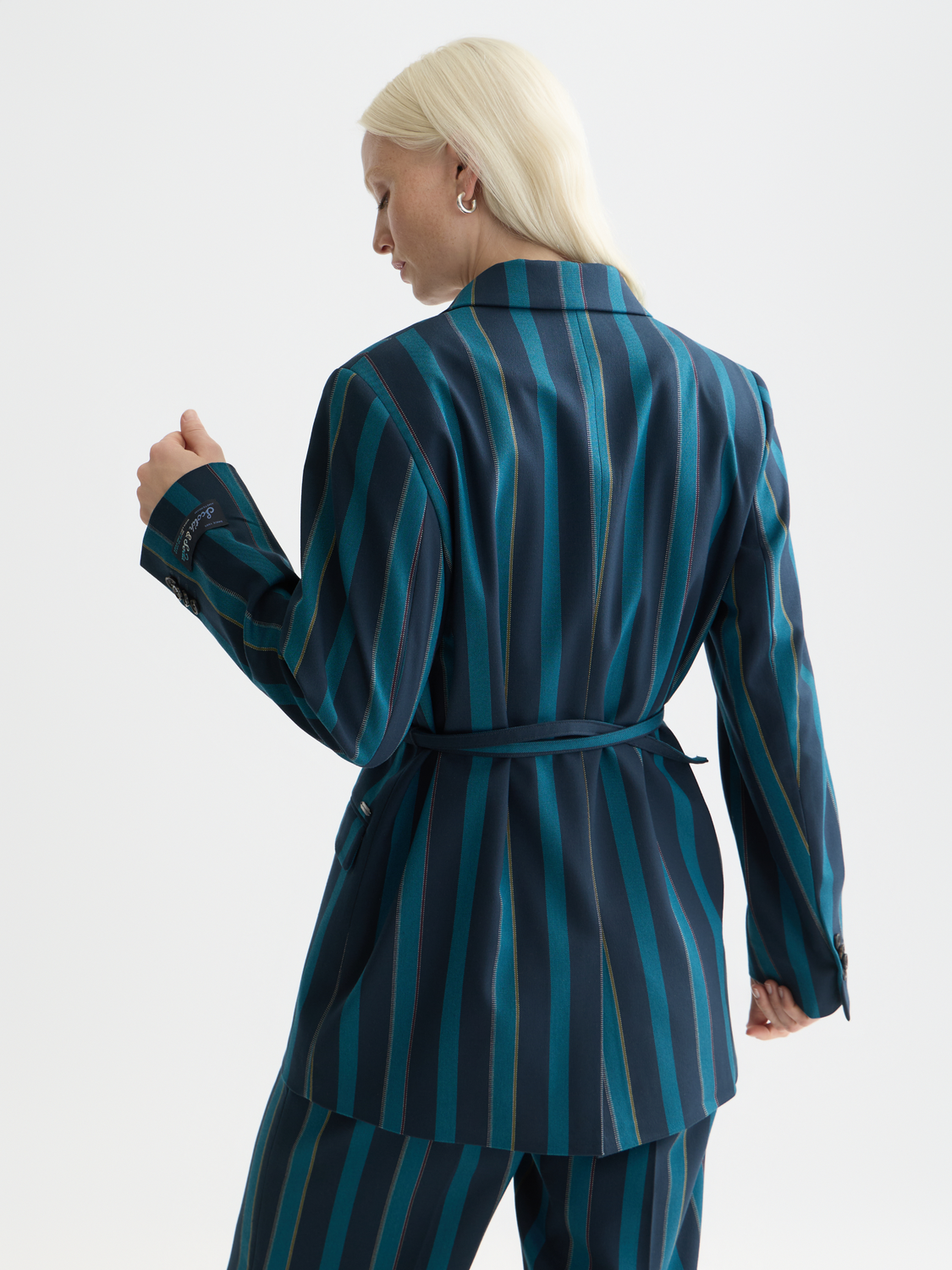 Double-breasted striped blazer by Scotch & Soda, shown from the back with classic navy and white vertical stripes and structured fit.