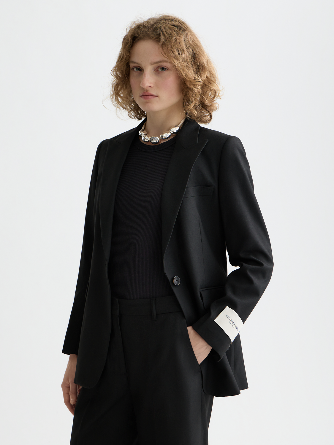 Fitted single-breasted blazer by Scotch & Soda in a tailored design, shown front view with lapels and button details.