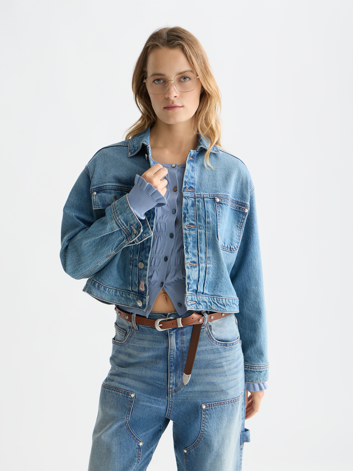Denim trucker jacket by Scotch & Soda featuring classic design, button front, and visible stitching on a model.